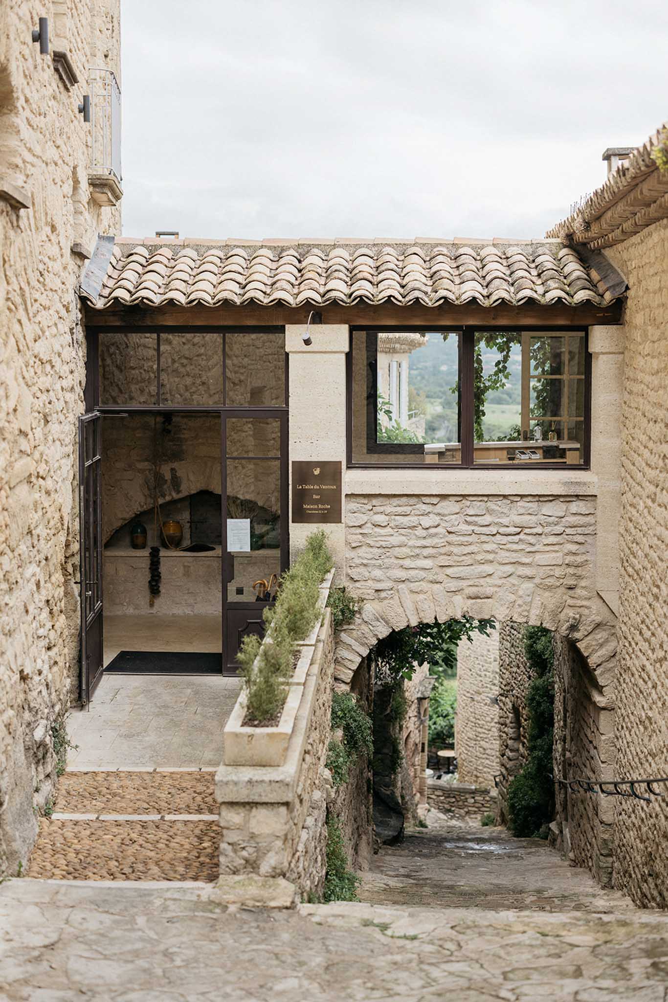 Historic stone courtyard entrance with cobblestones and medieval archways at wedding venue