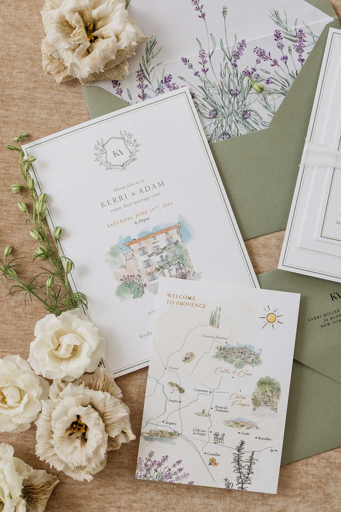 Wedding invitation suite with botanical illustrations and fresh flowers arranged on neutral linen