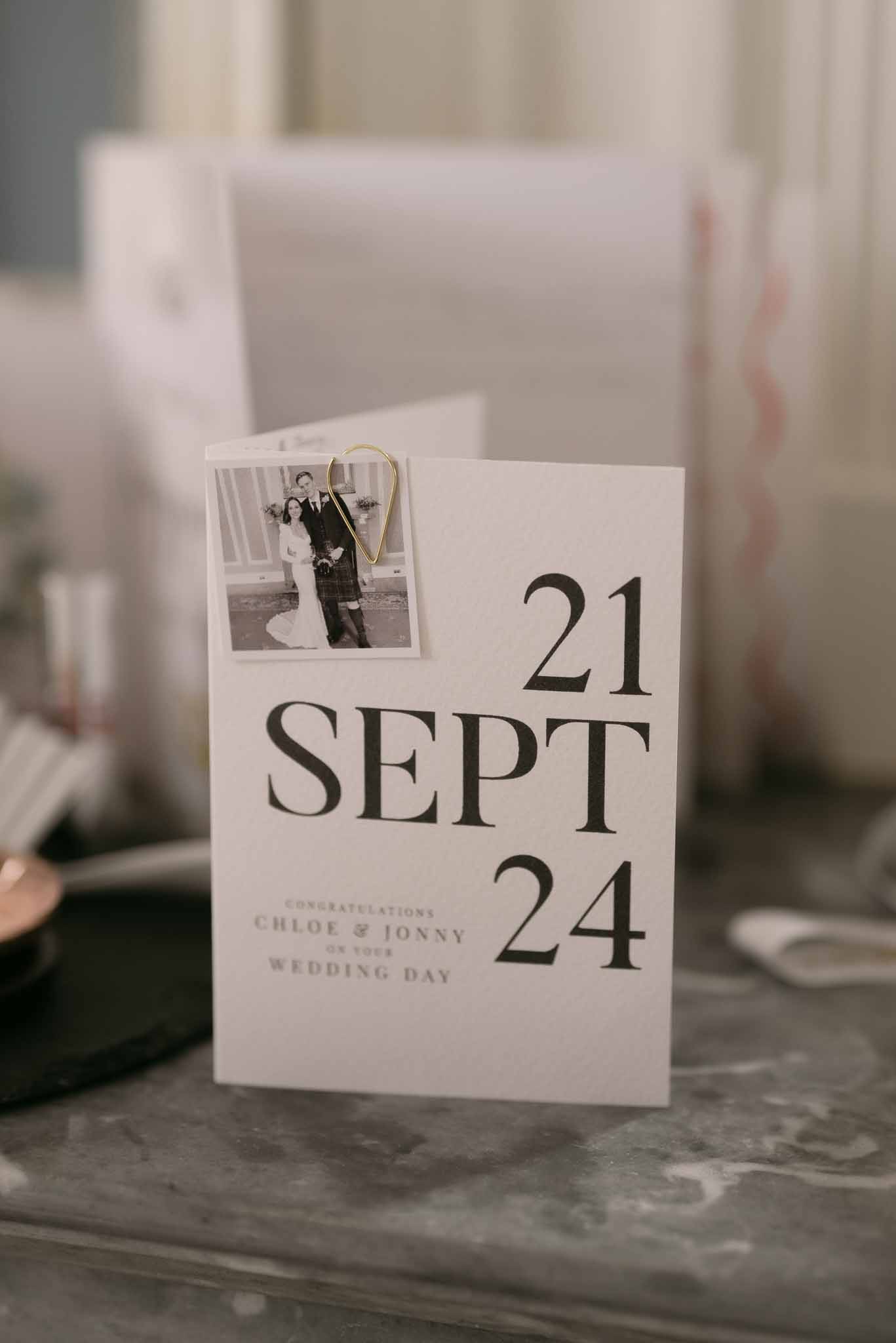 Wedding congratulations card with bold typography showing date 21 Sept 24 and couple Polaroid photo