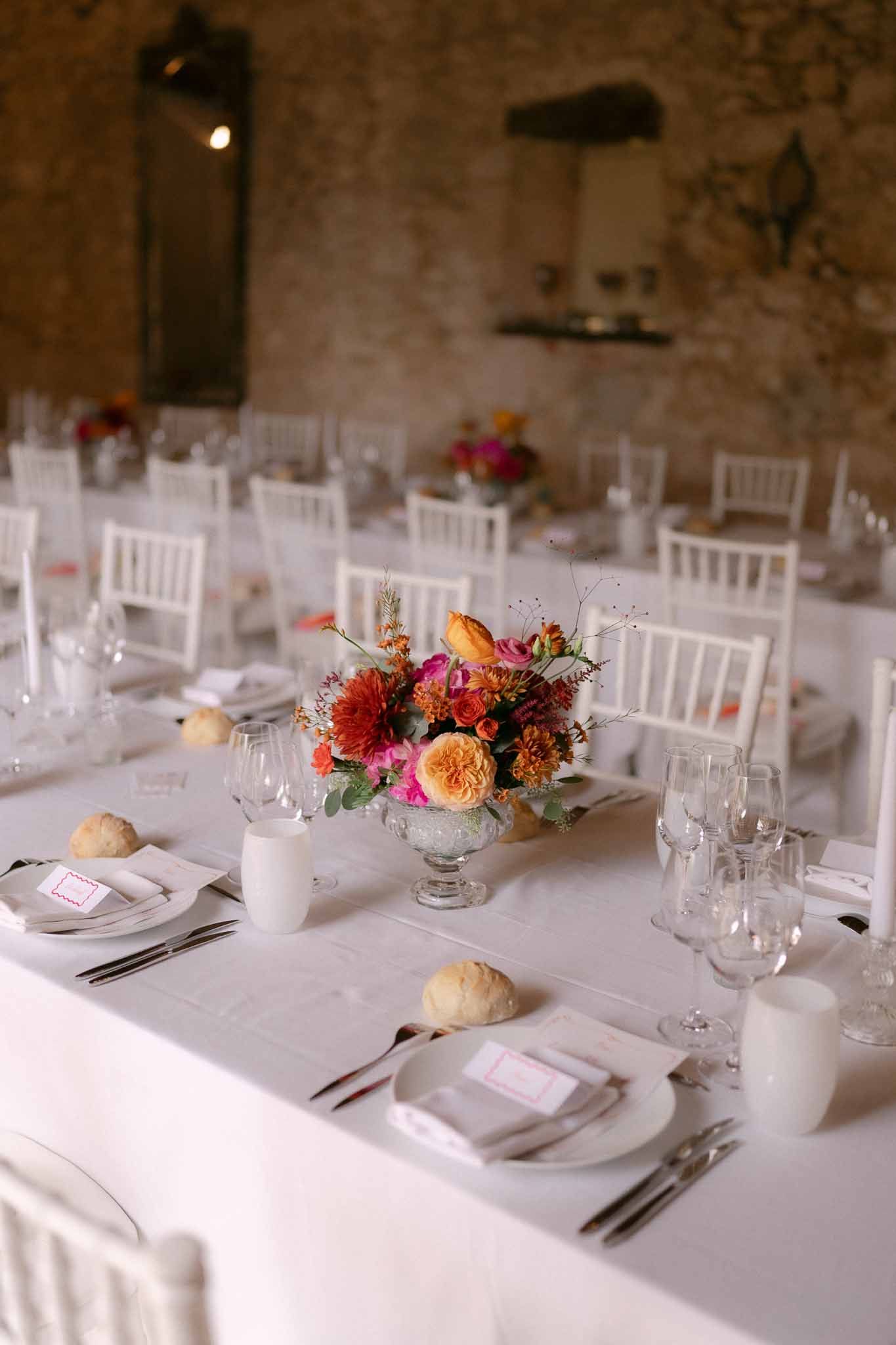 Wedding reception table setting in a garden with white roses