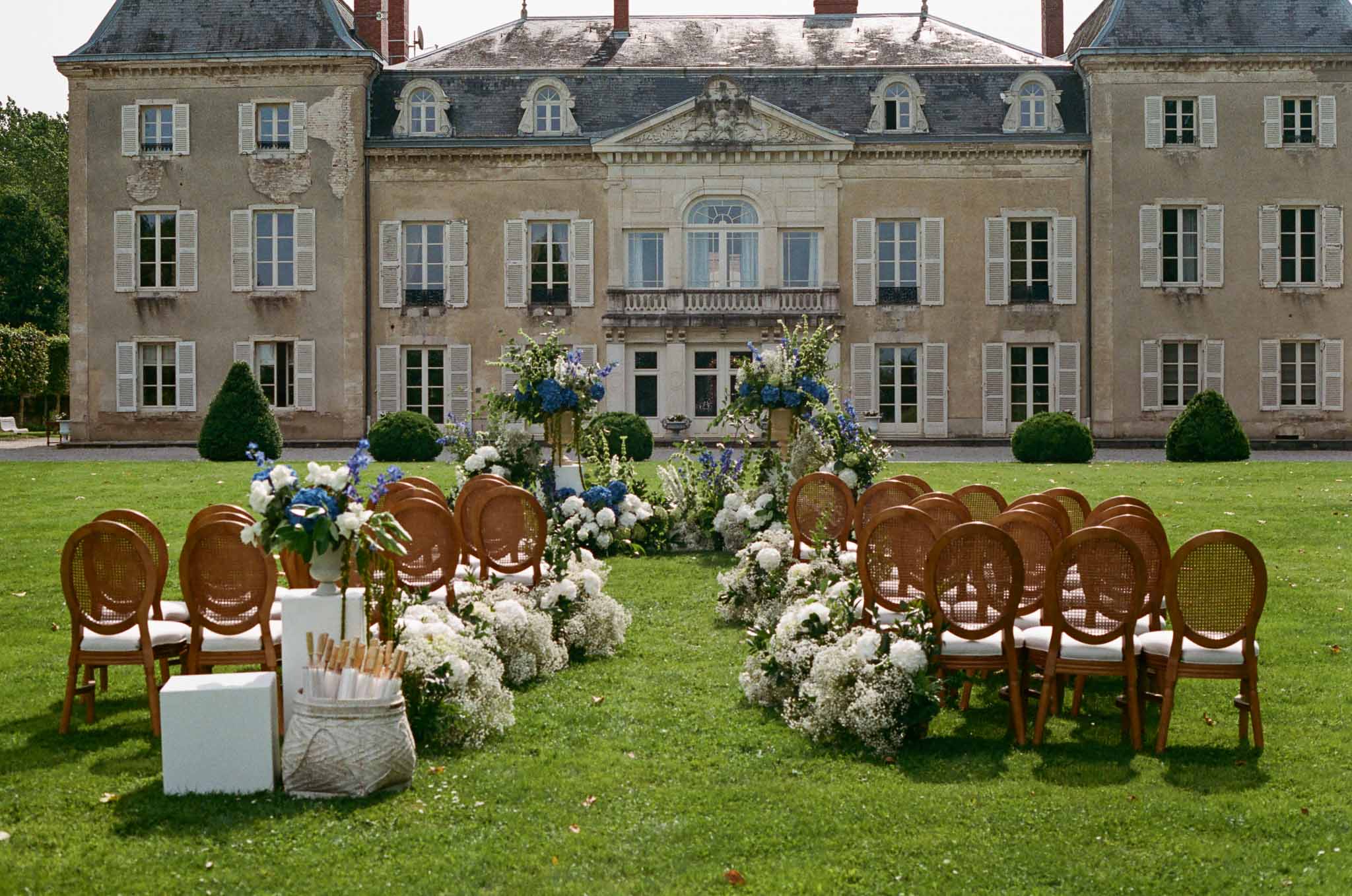 Wedding ceremony setup in a garden with hydrangeas