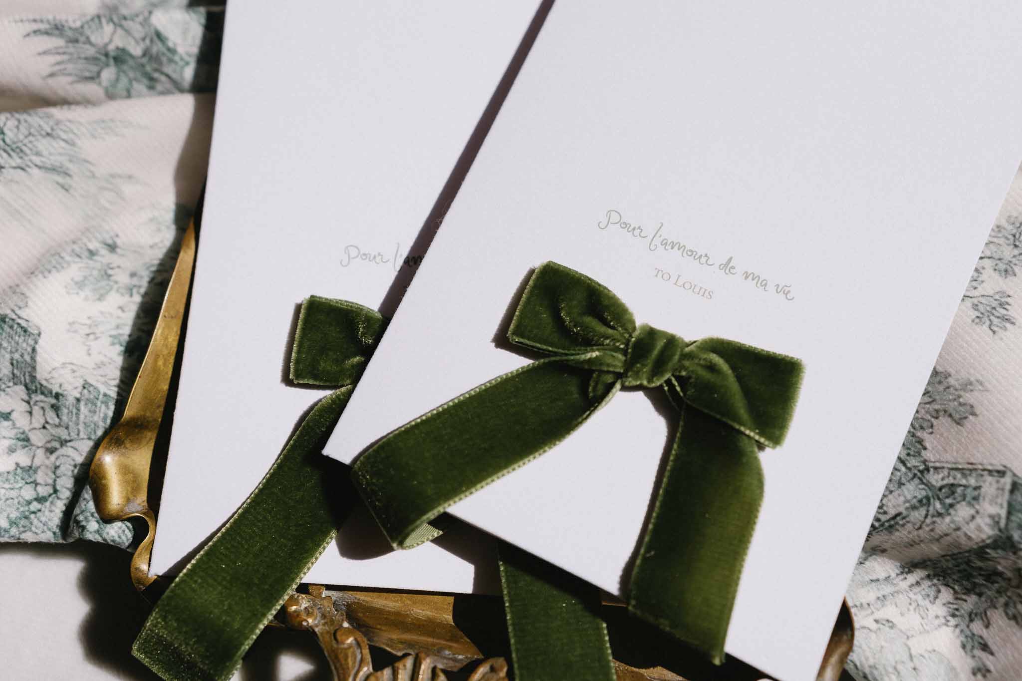 Wedding invitation flat lay with velvet ribbons and botanical print linens