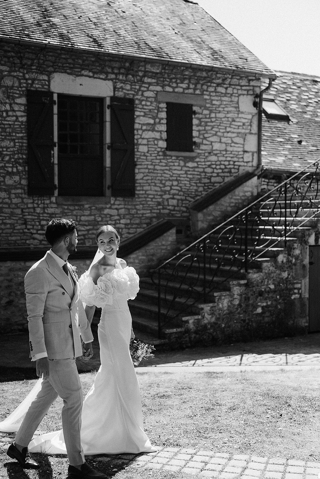 Bride and groom portrait in historic stone courtyard during wedding day