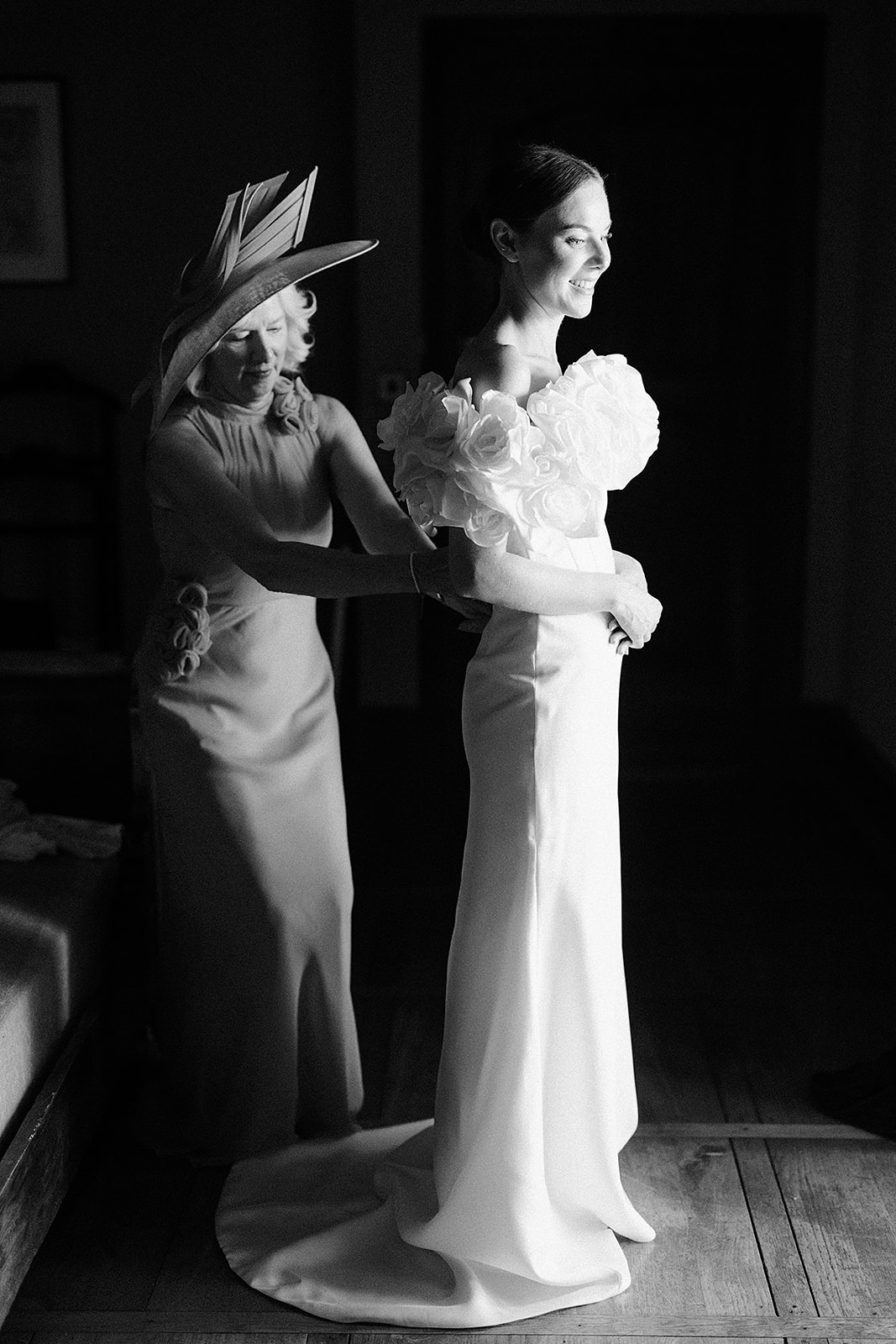 Bride with family member during getting ready moment in indoor venue space