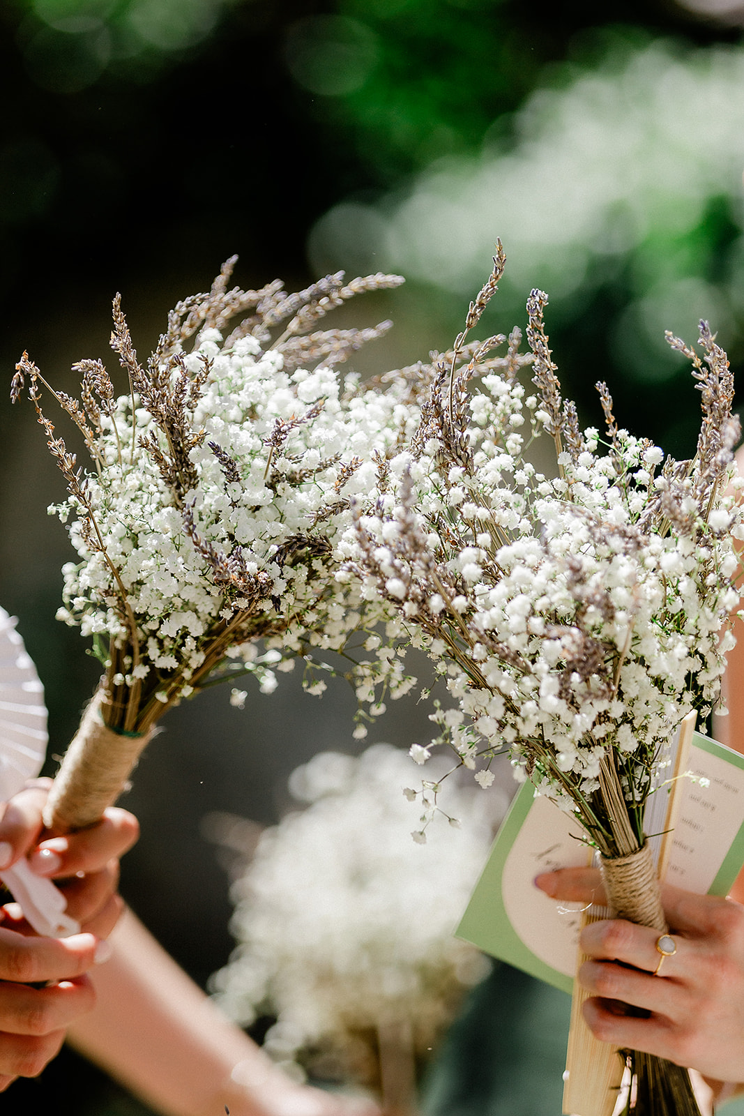 White baby's breath bridal bouquets with dried grasses at outdoor wedding ceremony