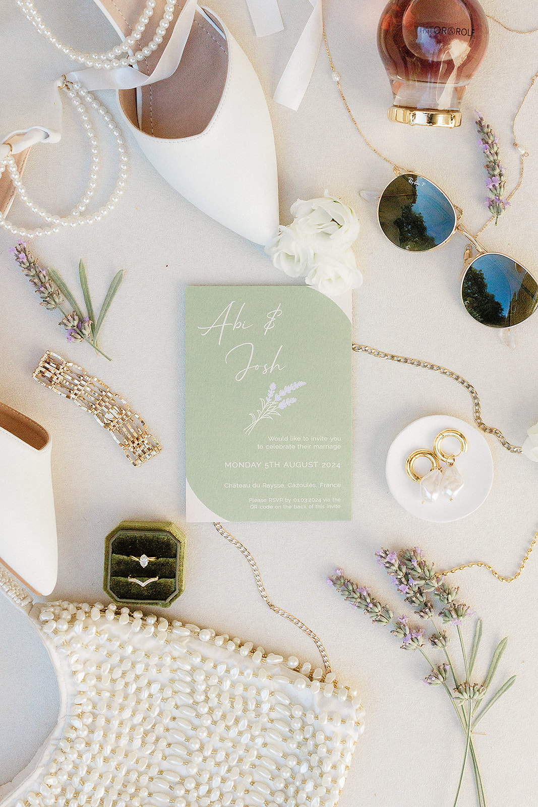 Wedding flat lay with invitation, rings, shoes and accessories on beige background