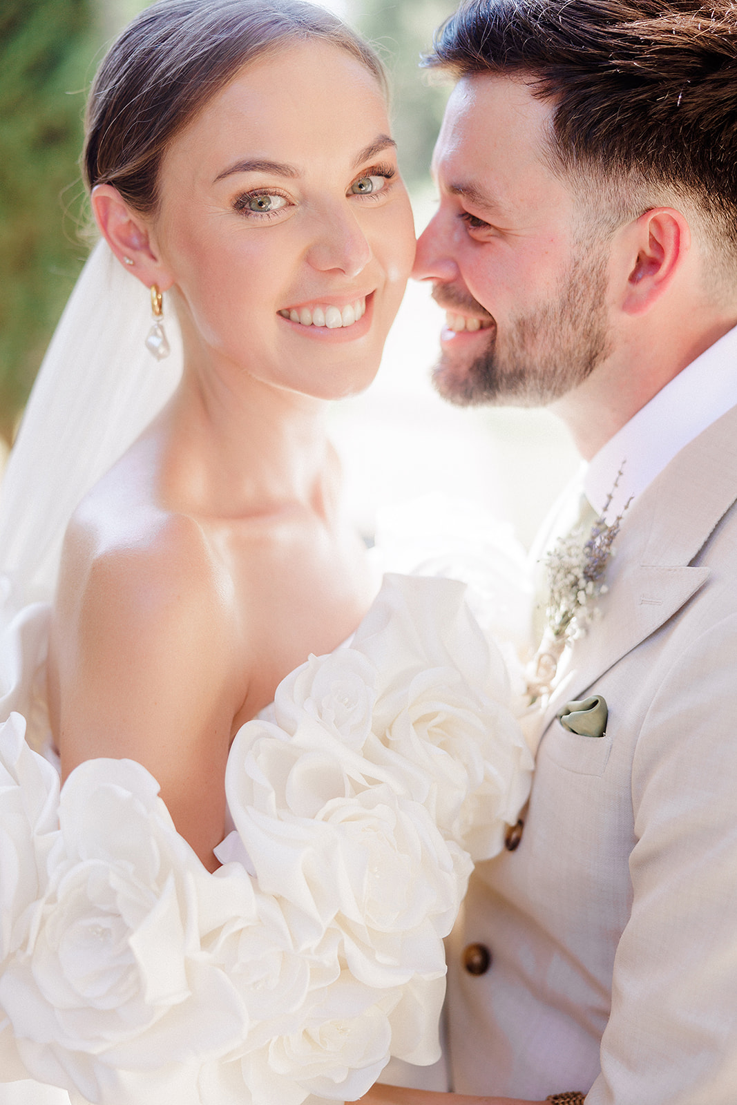 Bride and groom sharing intimate moment in close-up portrait outdoors