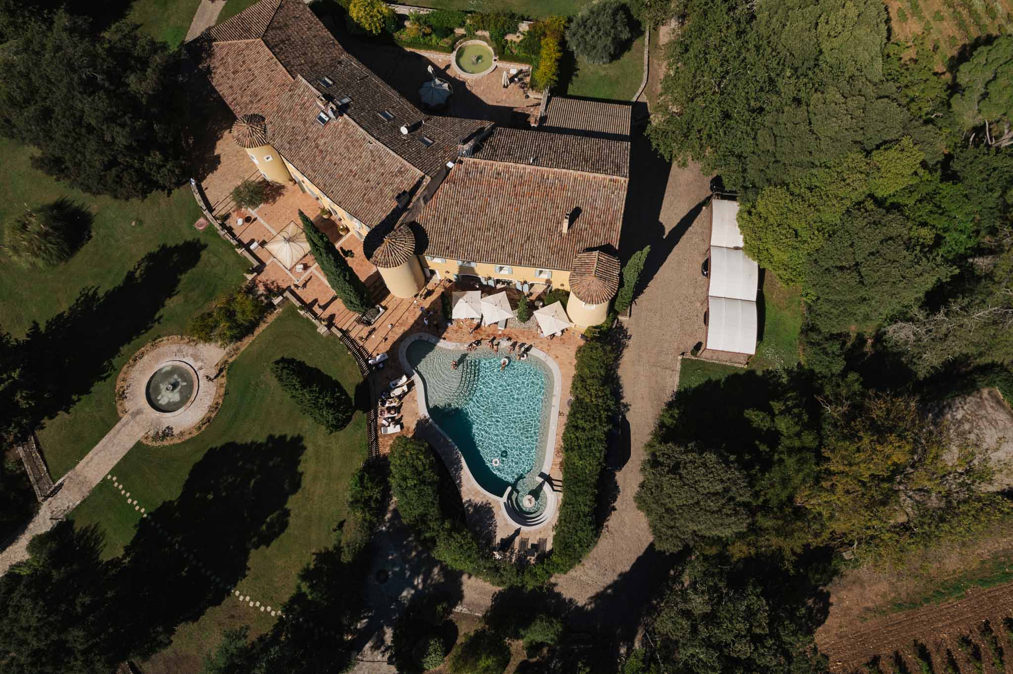 Aerial view of Tuscan villa wedding estate with swimming pool and manicured gardens