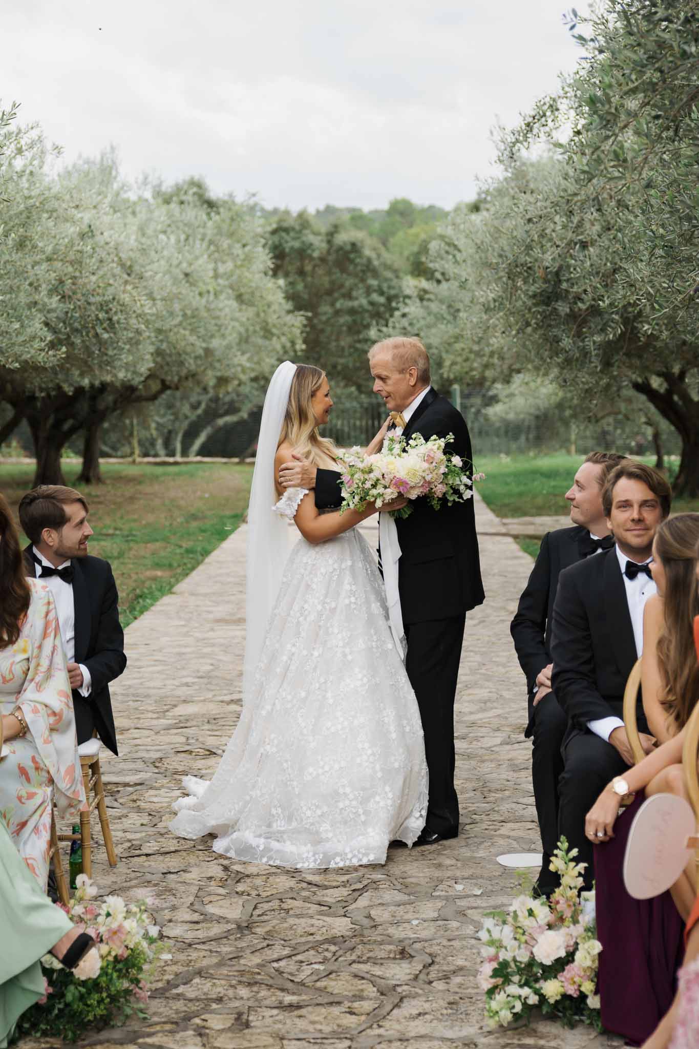 Bride and groom exchanging vows during outdoor ceremony in Mediterranean olive grove
