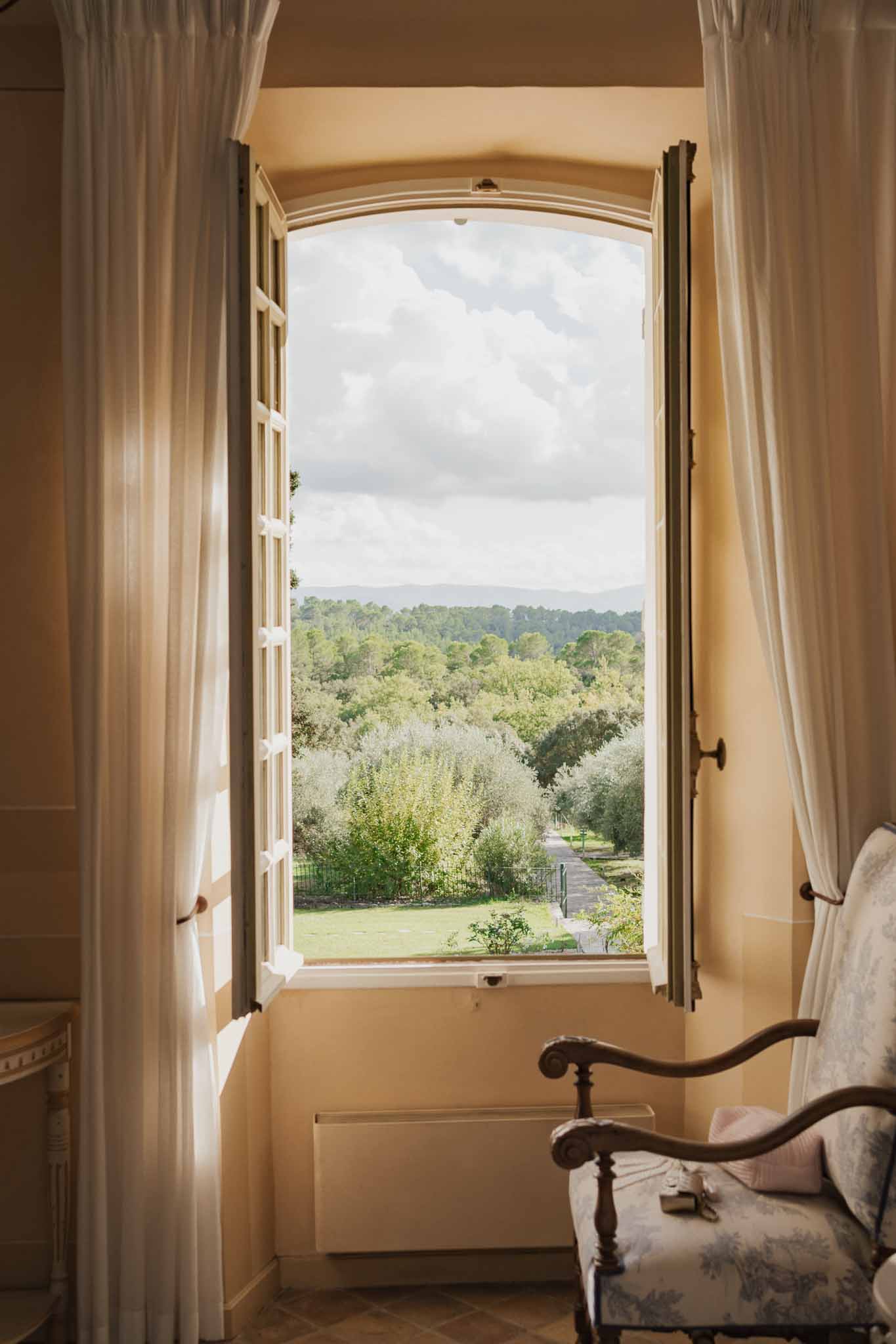 Interior room with wooden shutters overlooking countryside grounds at classic wedding venue