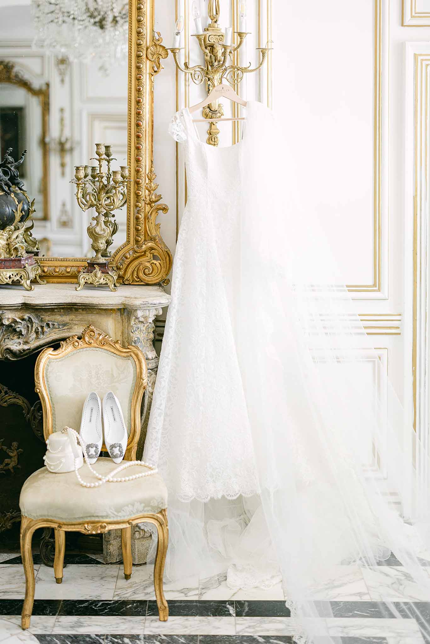 Bridal dress and accessories arranged in ornate classical interior salon