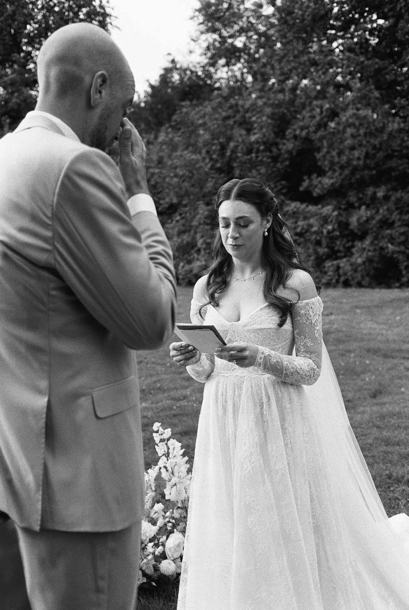 Bride and groom exchanging vows during intimate garden wedding ceremony