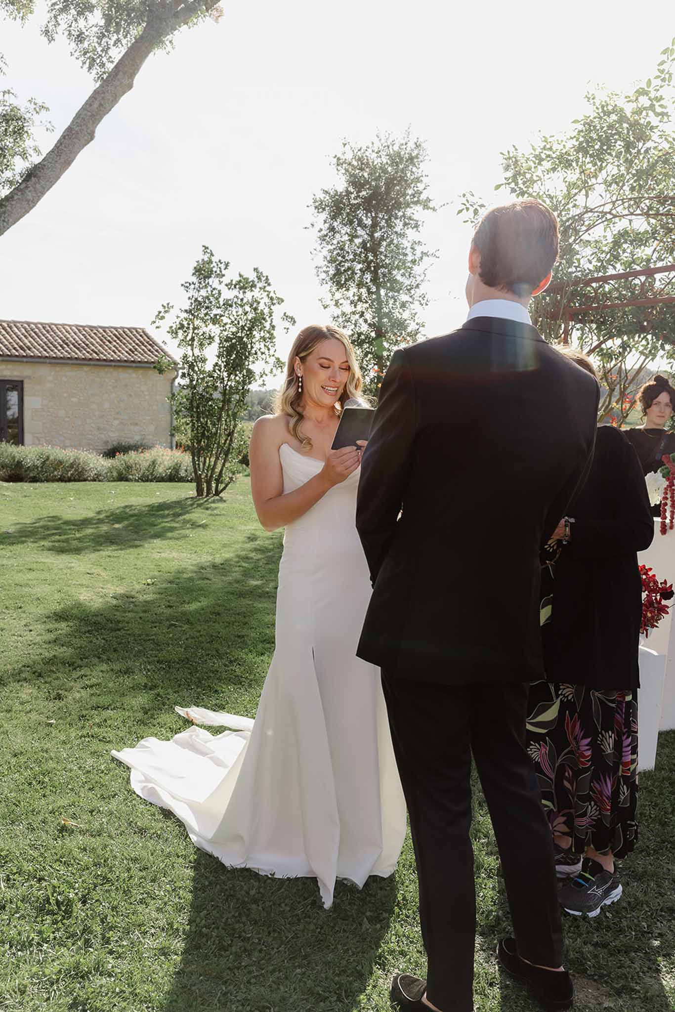 Bride and groom exchanging vows during outdoor ceremony at French countryside estate