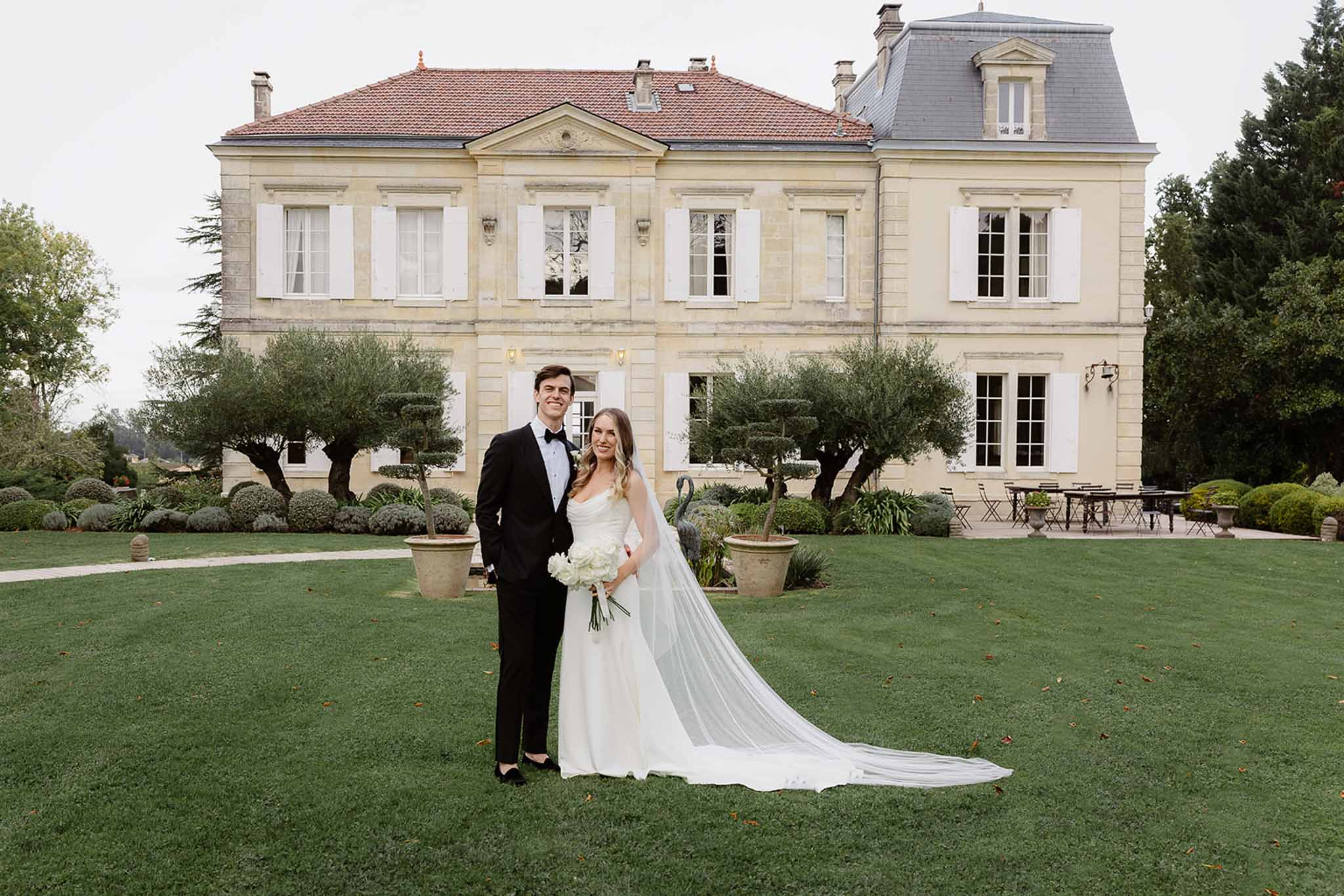 Bride and groom formal portrait on lawn at French neoclassical estate