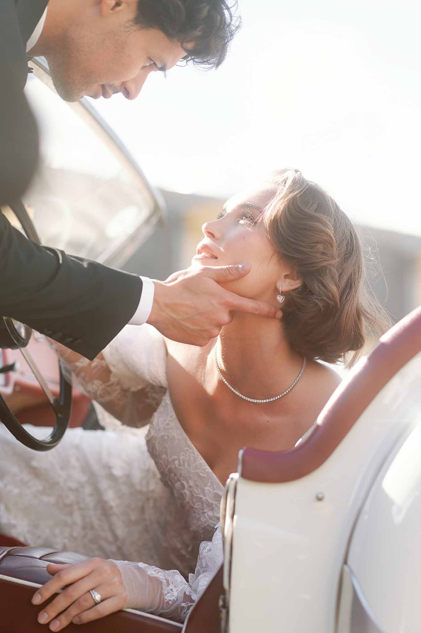 Bride and groom in intimate portrait moment outdoors with natural backlighting