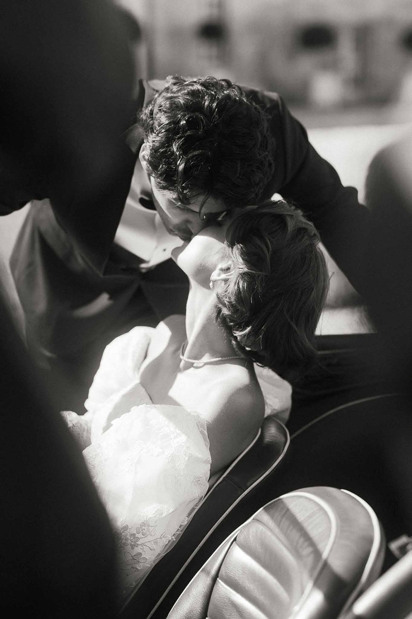 Intimate black and white portrait of bride and groom during wedding celebration
