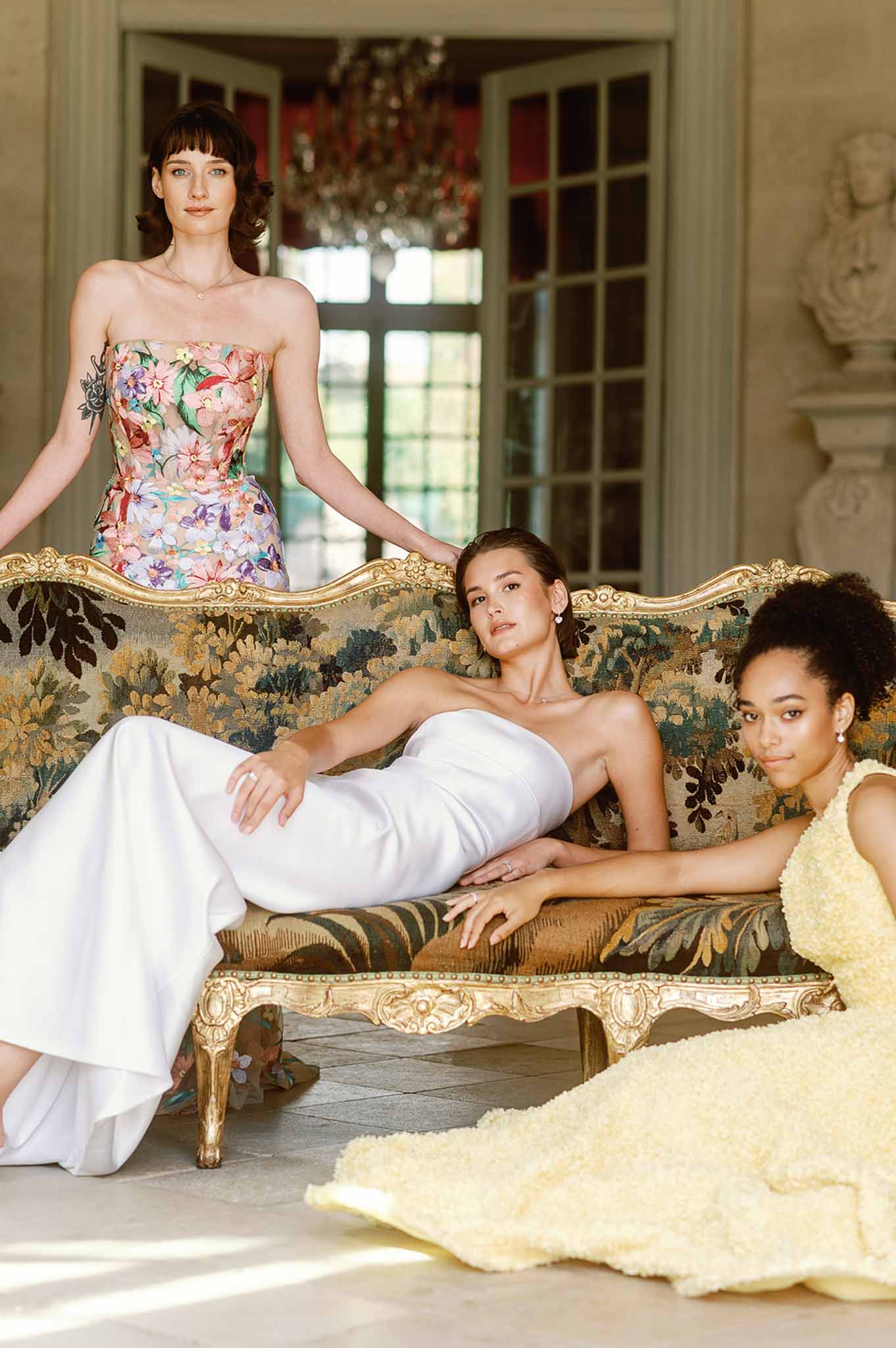 Bride and bridesmaids portrait in classical salon with ornate furniture and formal decor