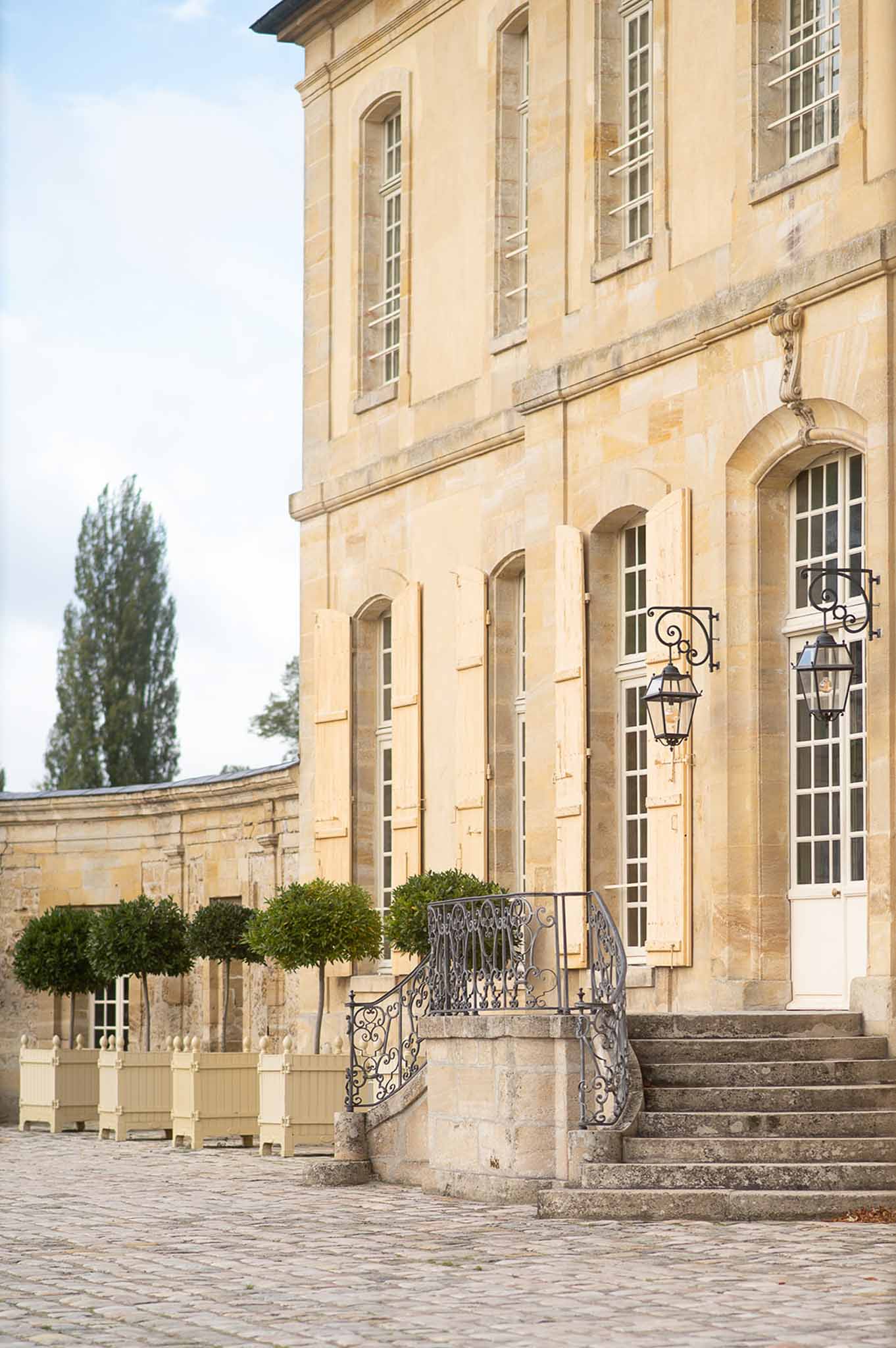 Classical stone building exterior with Georgian architecture and formal courtyard at wedding venue
