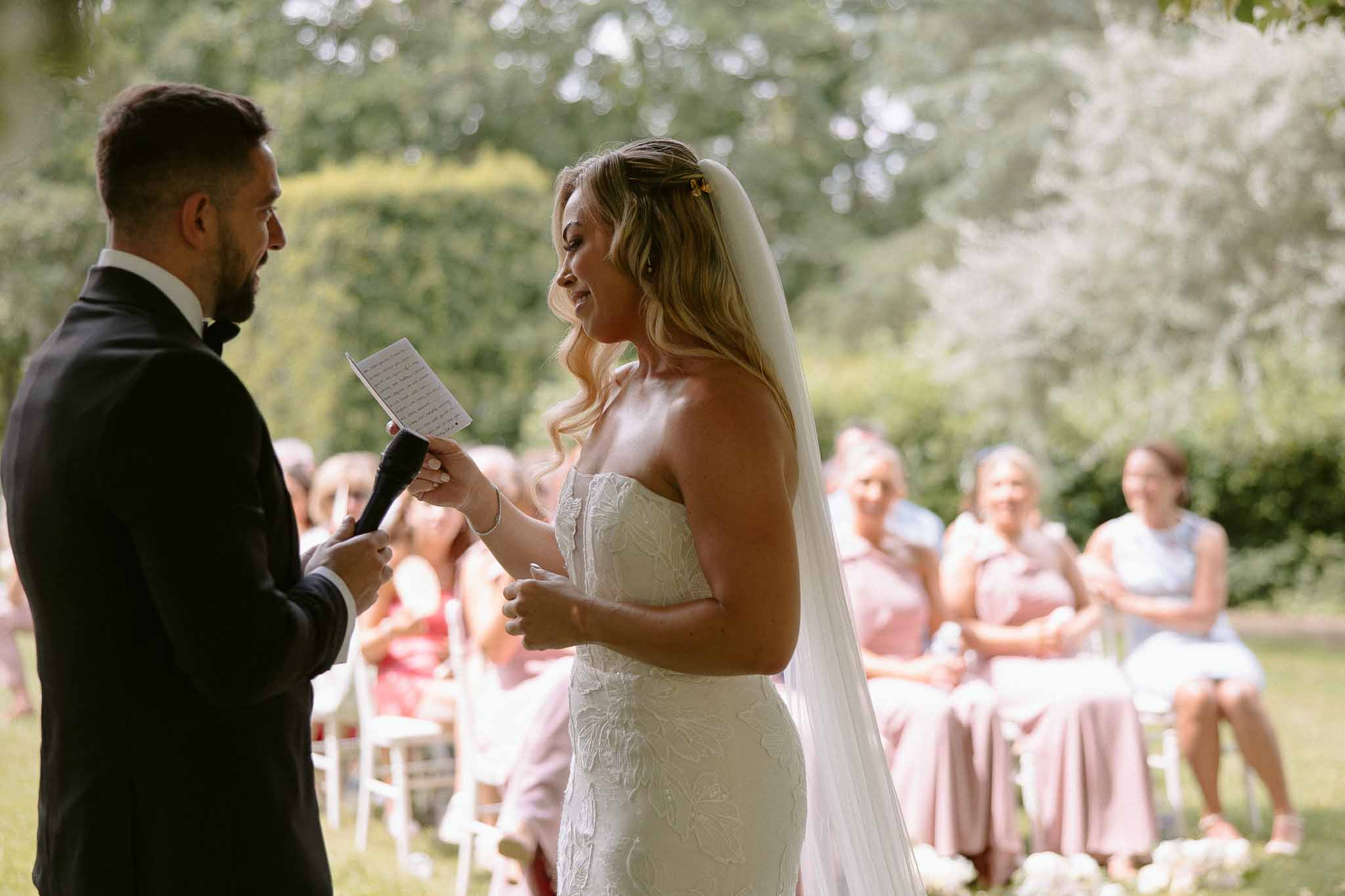 Bride and groom exchanging vows during outdoor garden wedding ceremony