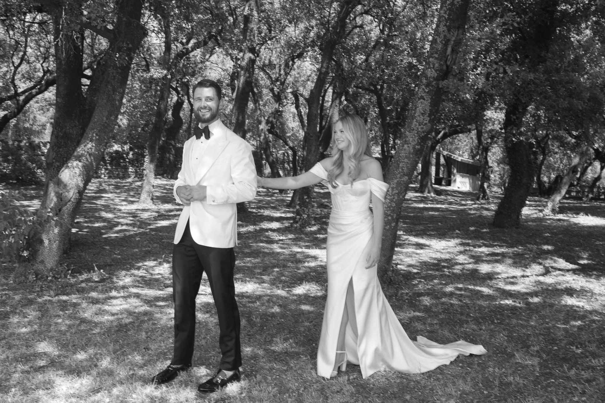 Bride and groom portrait session in wooded garden setting with dappled natural lighting