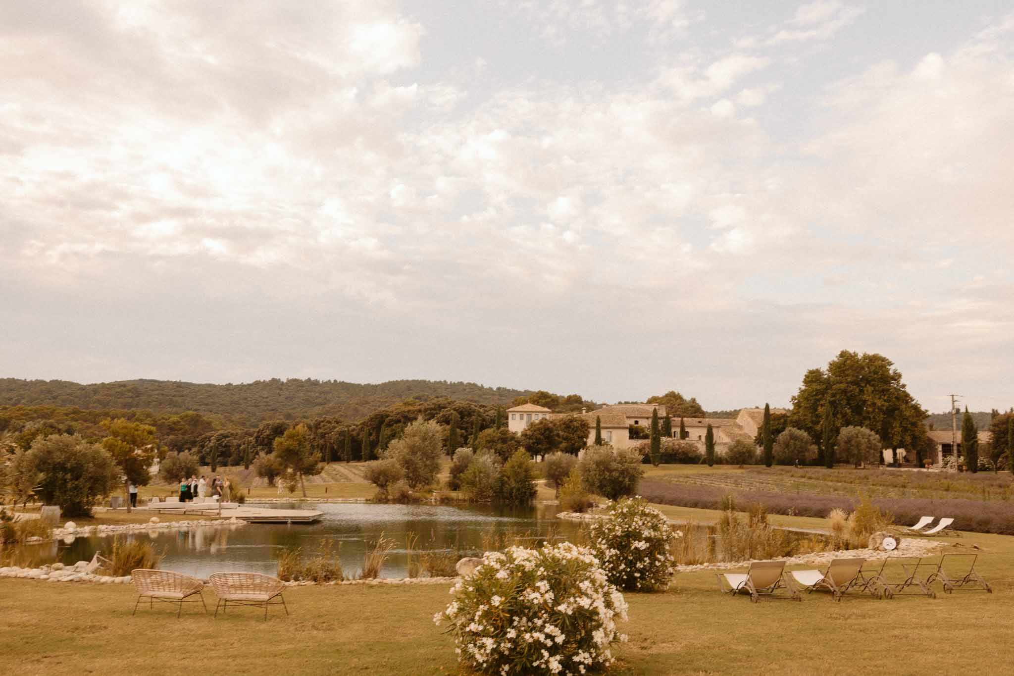 Outdoor reception venue with pond view and Tuscan villa in rural countryside setting
