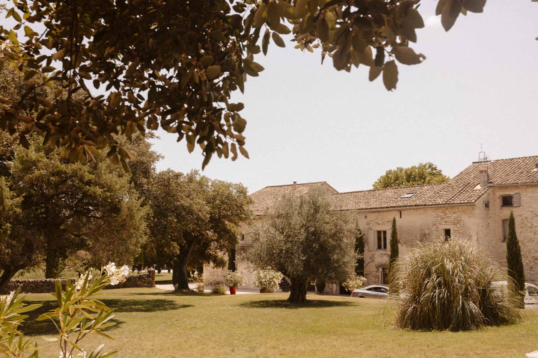 Stone farmhouse wedding venue exterior with Mediterranean courtyard and olive trees