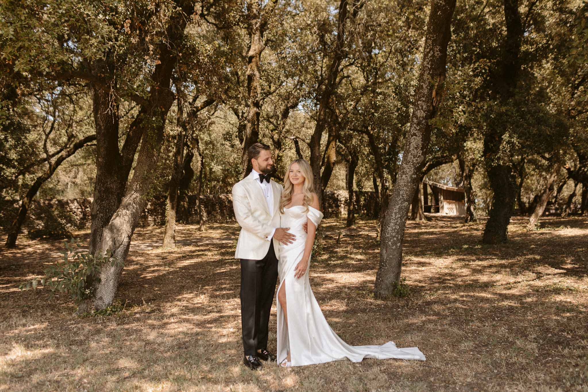 Bride and groom portrait under oak trees at historic estate wedding venue