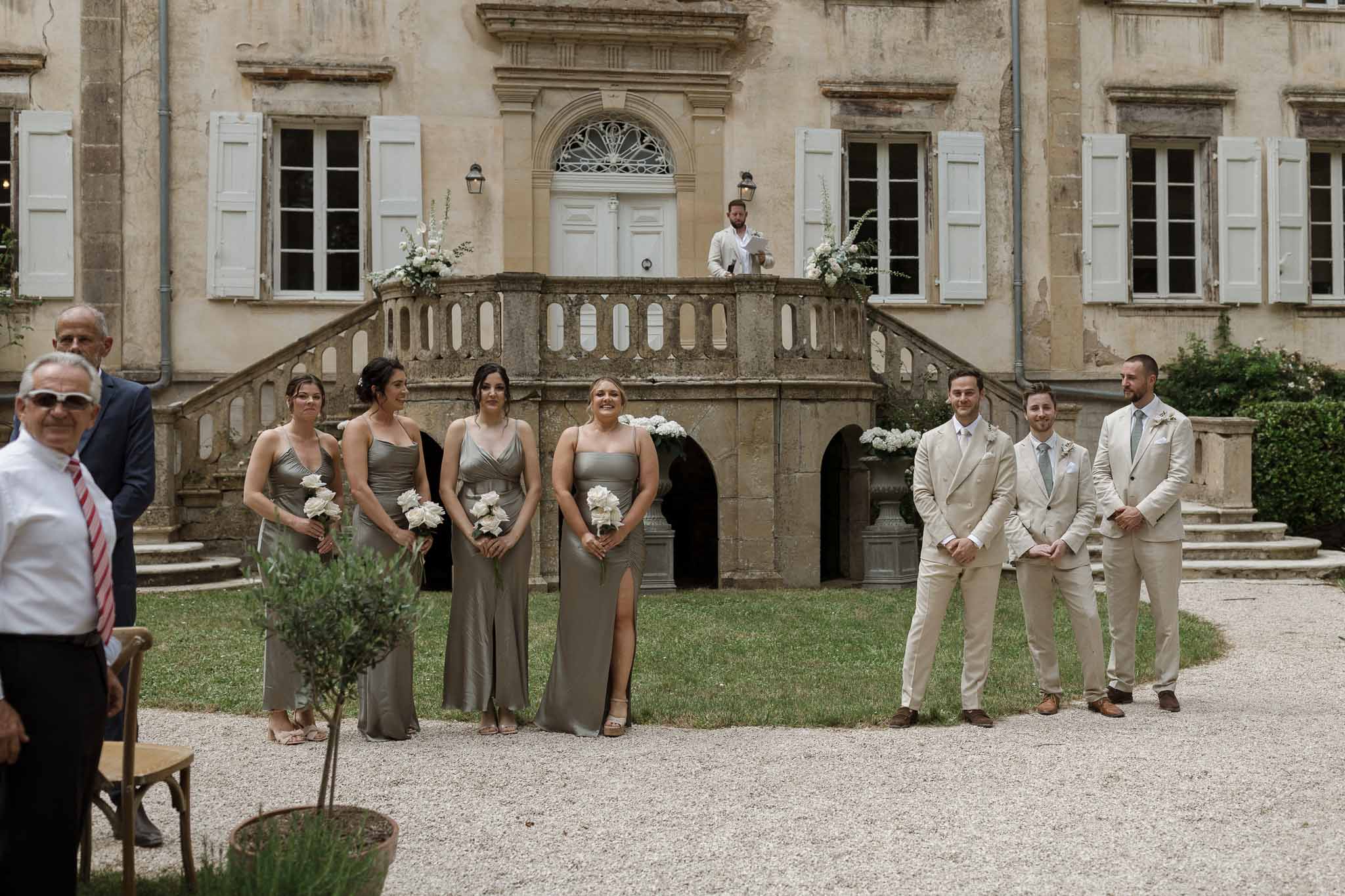 Formal bridal party portrait in historic château courtyard with classical architecture