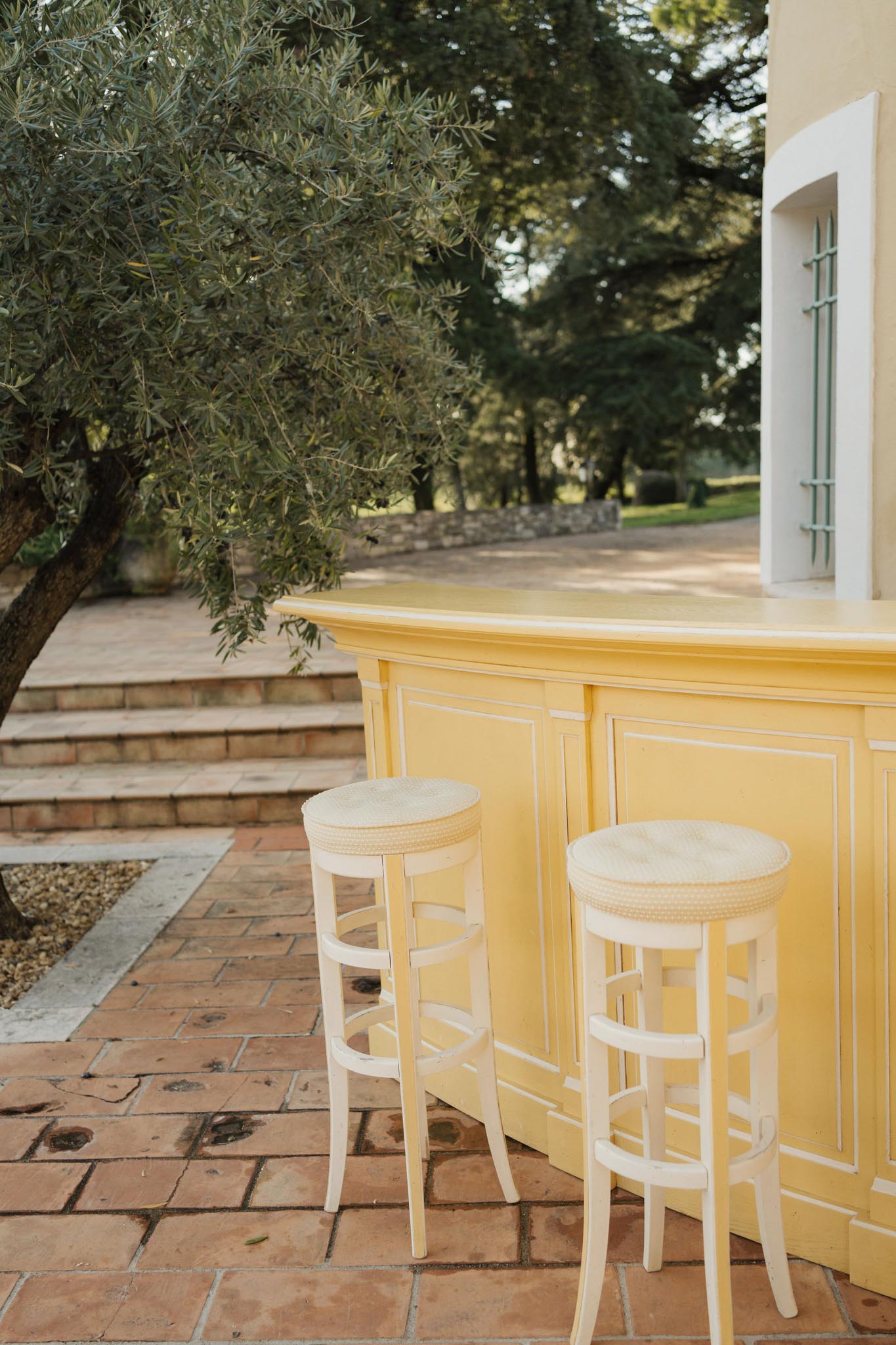 Outdoor cocktail bar setup on terracotta terrace at Mediterranean villa wedding venue
