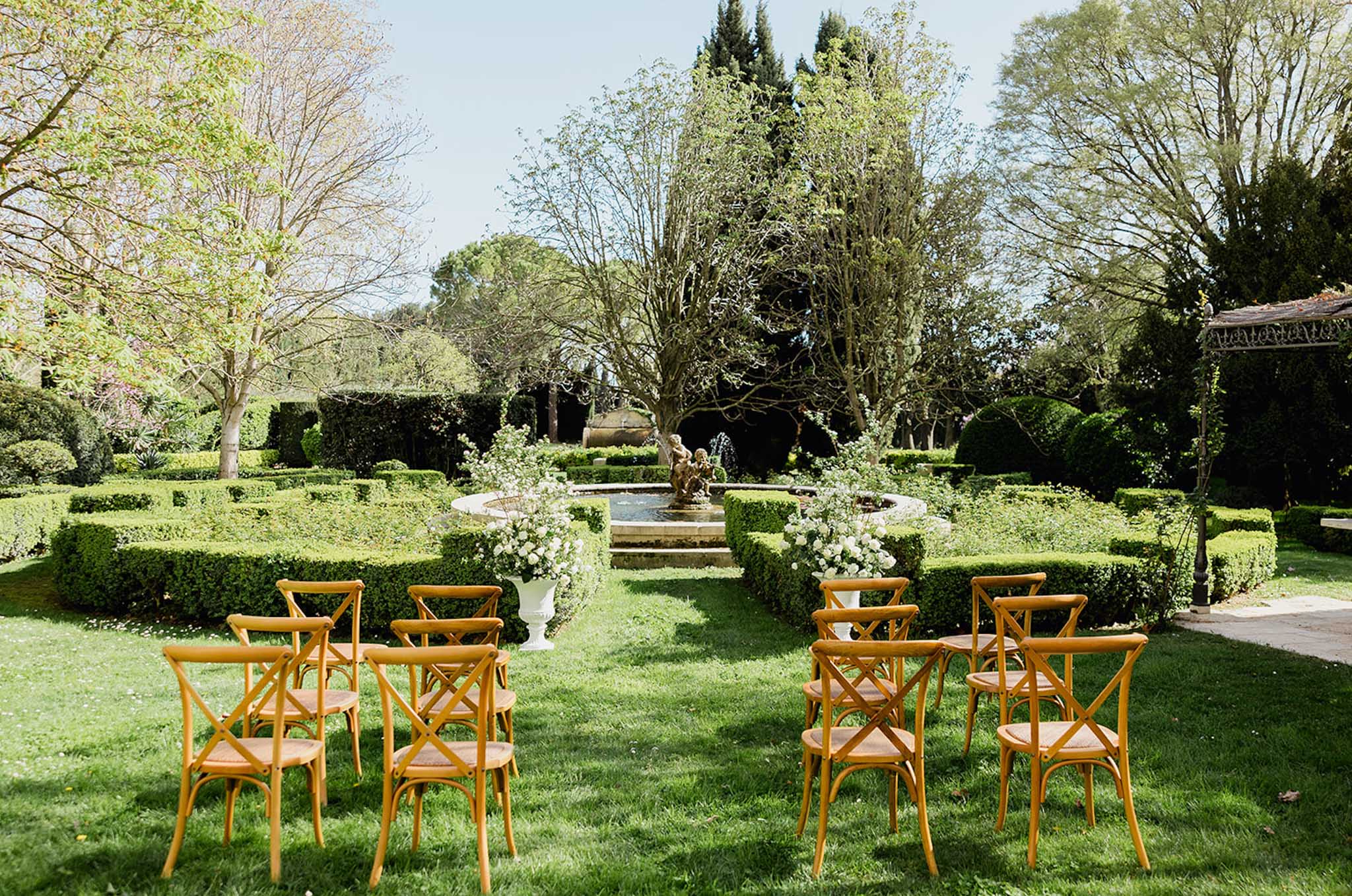 Wedding ceremony setup in a garden with white roses
