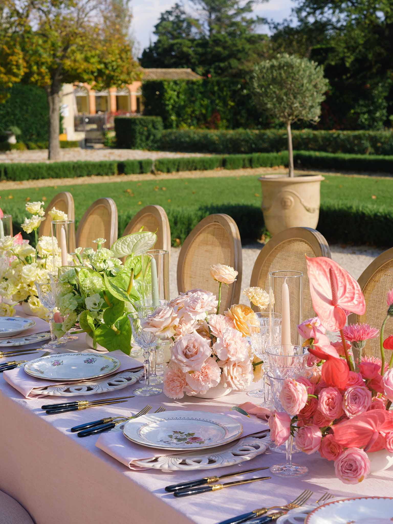 Elegant reception table setting with lavender linens and floral centerpieces in formal garden