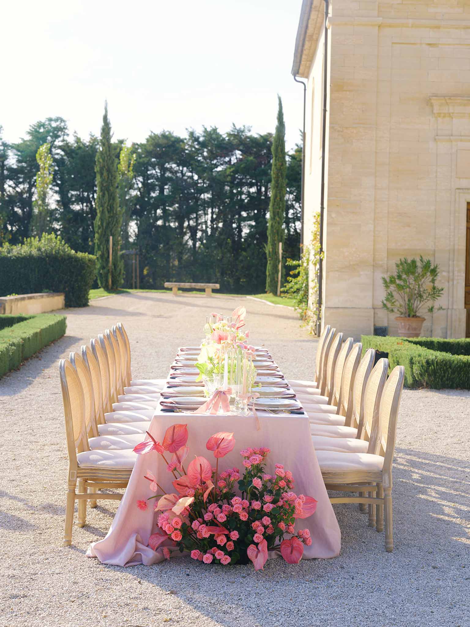 Outdoor reception table setting with pink florals at stone manor courtyard