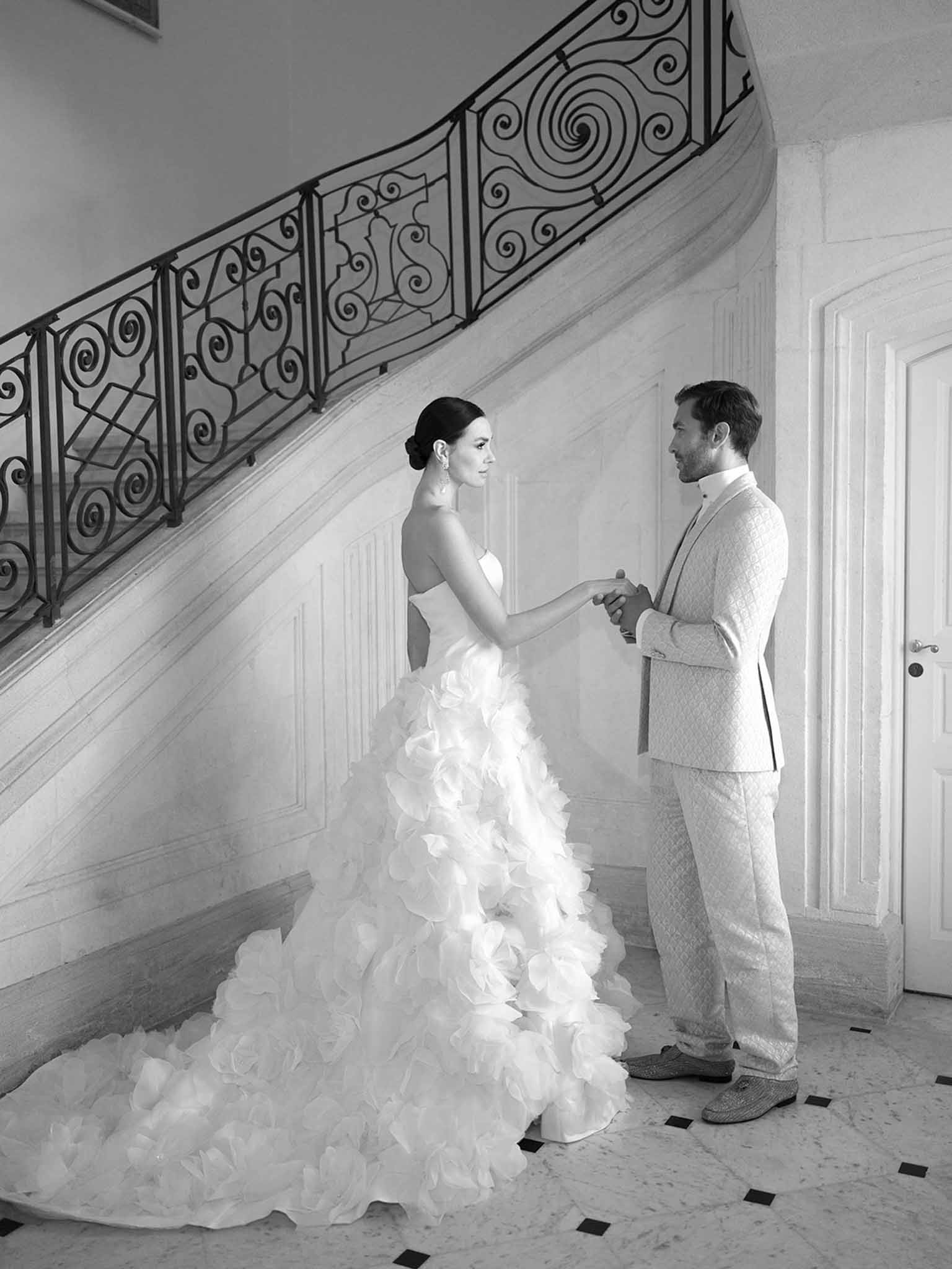 Bride and groom exchanging vows on elegant interior staircase with classical architectural details