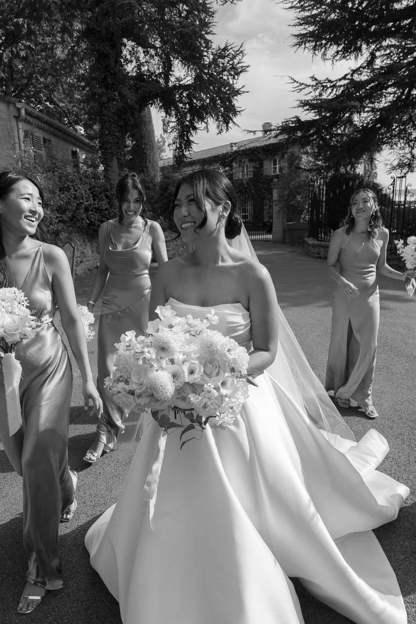 Bridal party portrait with bride and bridesmaids in historic stone courtyard garden