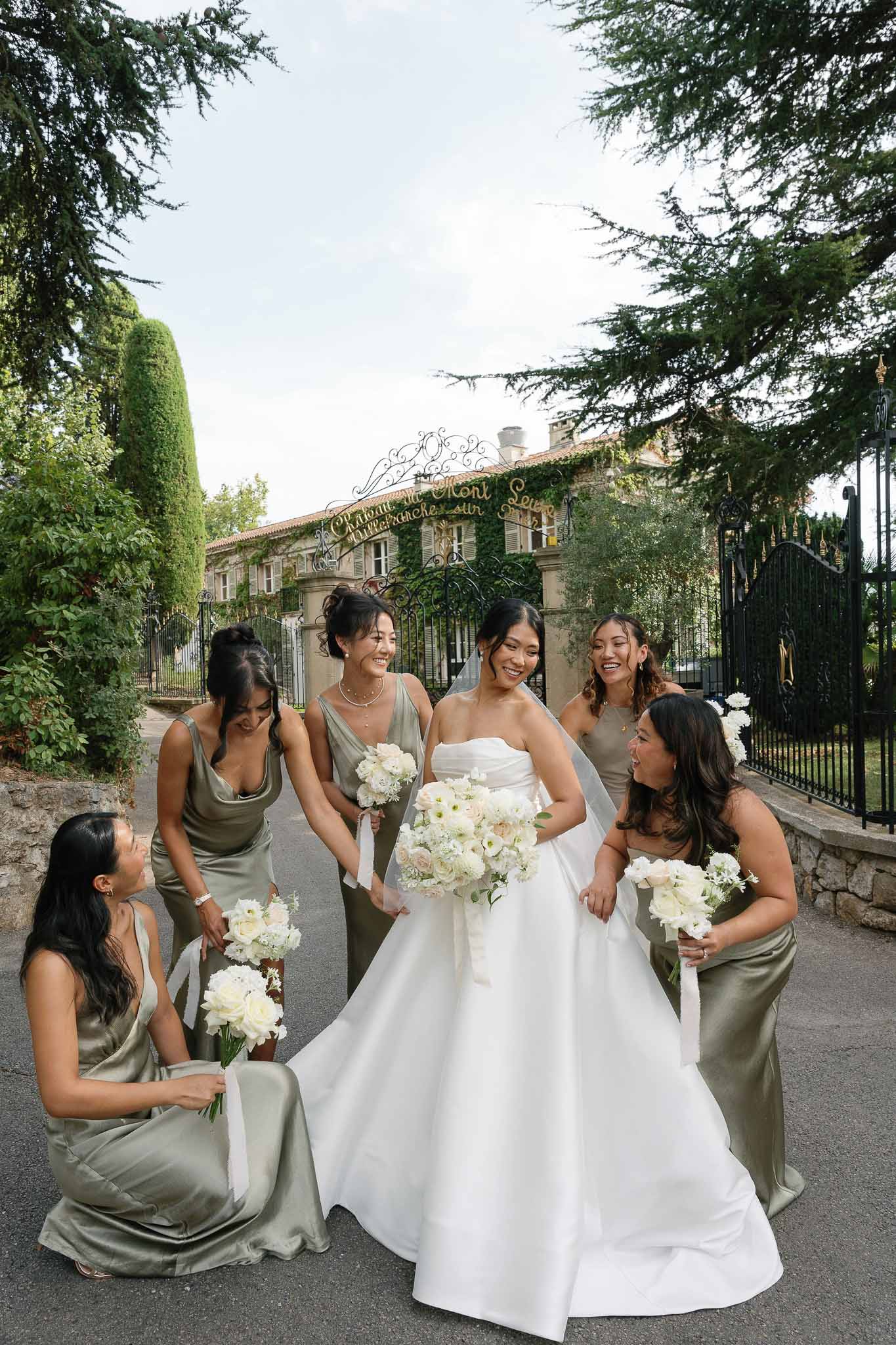Bridal party portrait with bride and bridesmaids at stone villa with ivy-covered walls