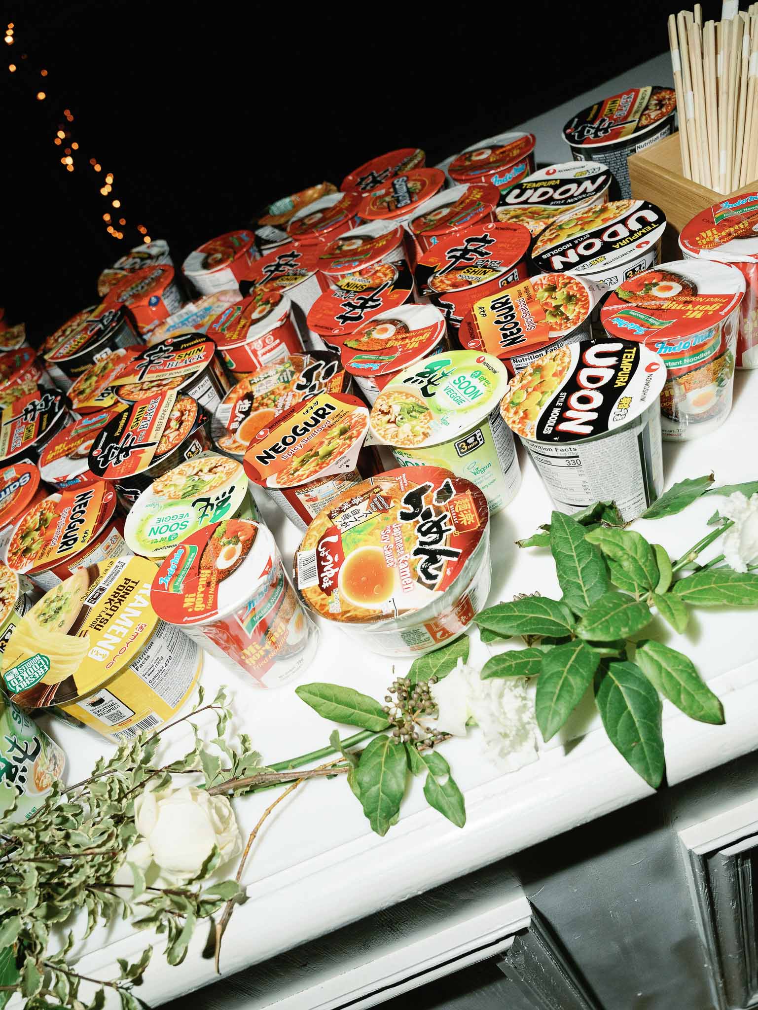 Styled ramen noodle display with herbs and chopsticks for wedding late-night snack station