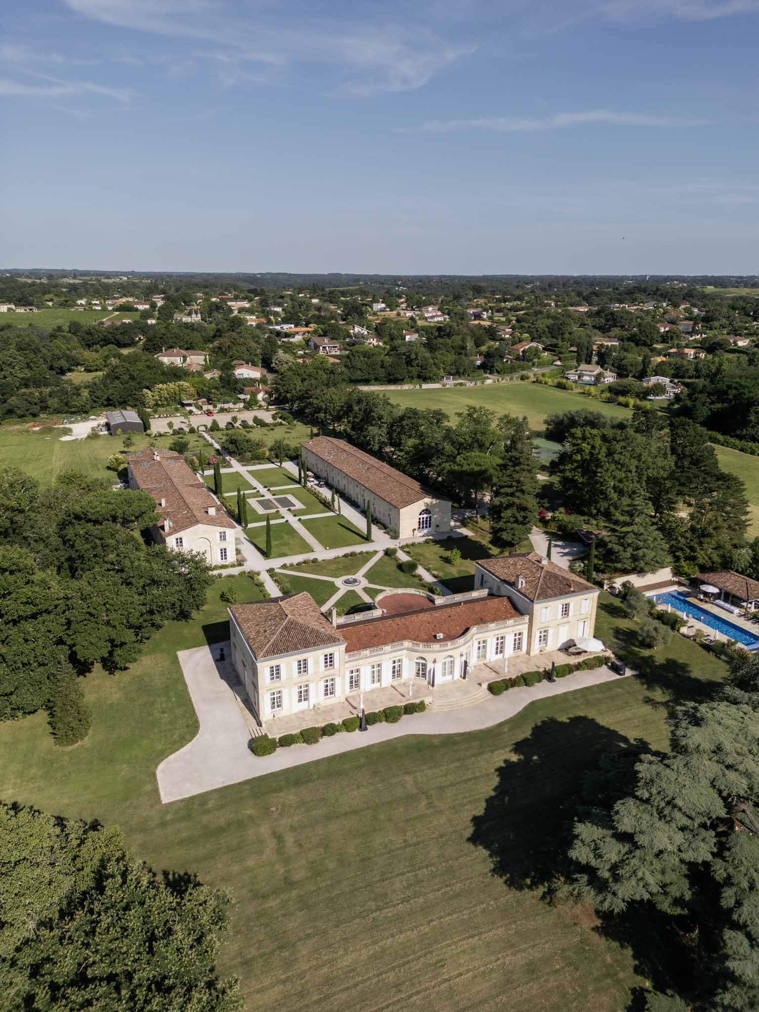 Aerial view of French château wedding venue with formal gardens and terracotta roof