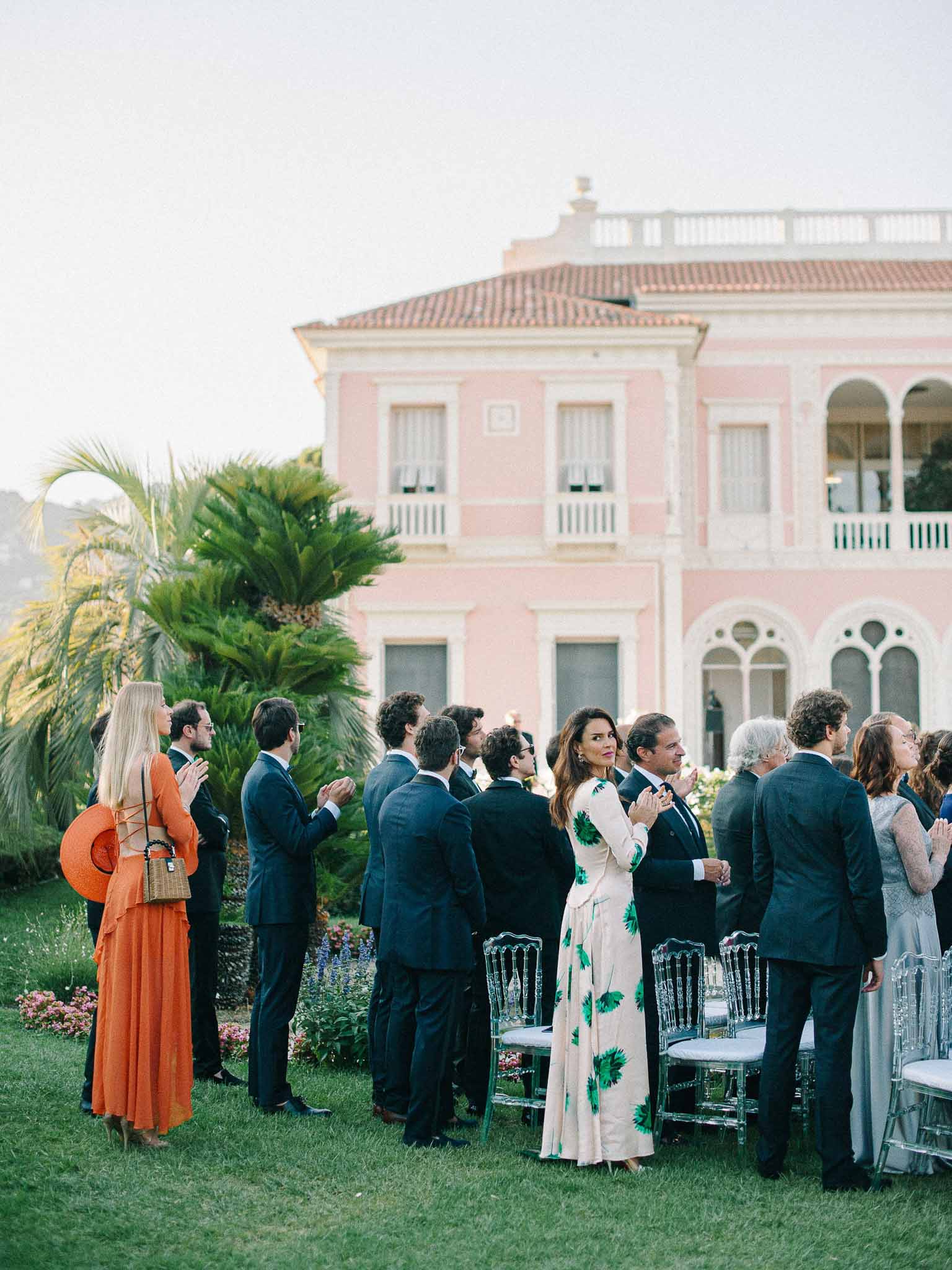 Guests mingling during cocktail hour on mansion lawn at neoclassical wedding venue