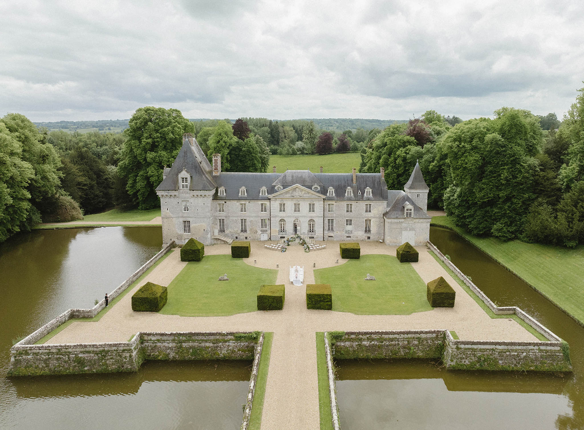 Aerial view of French château wedding venue with formal gardens and manicured grounds