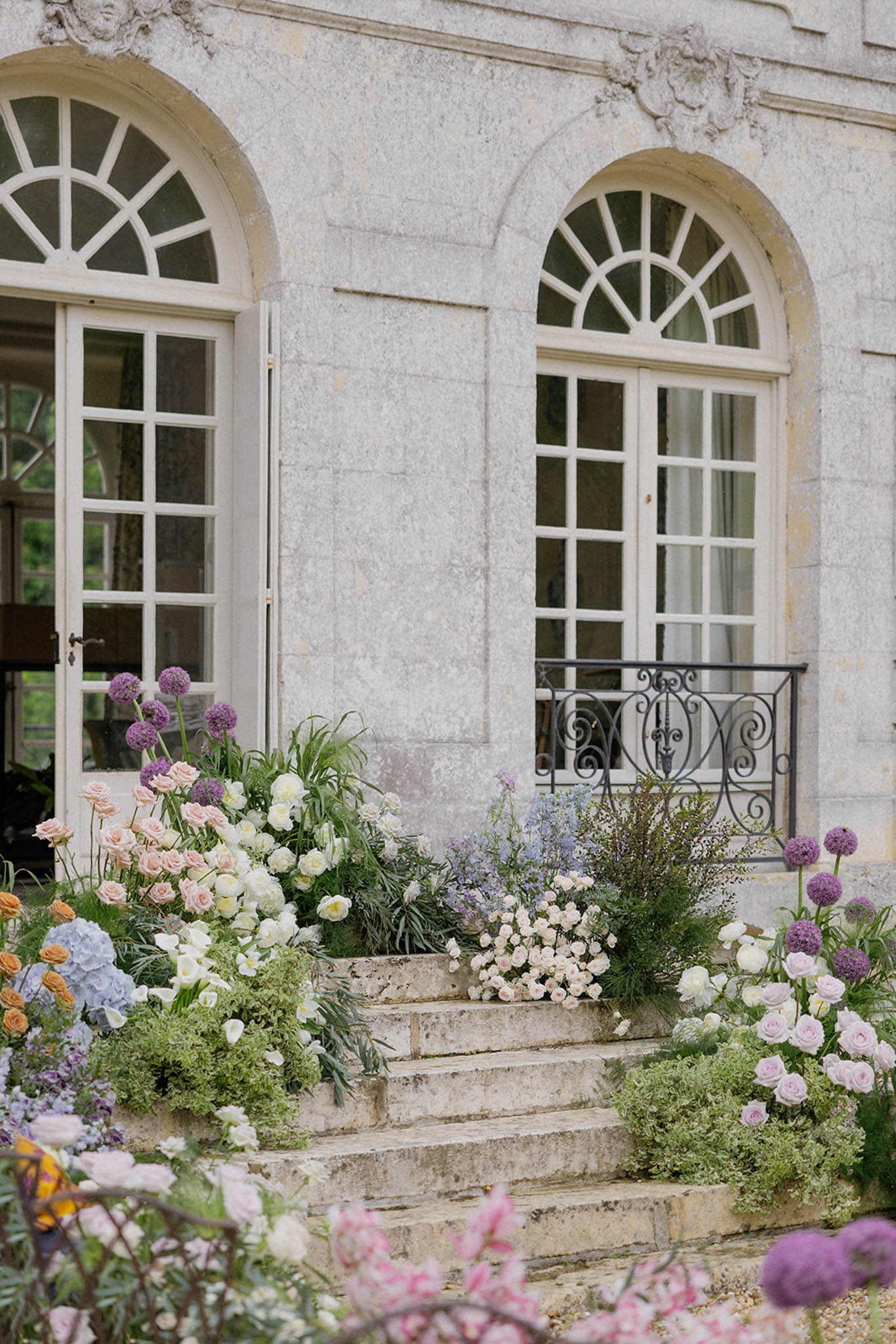 Classical stone building entrance decorated with wedding florals at elegant venue