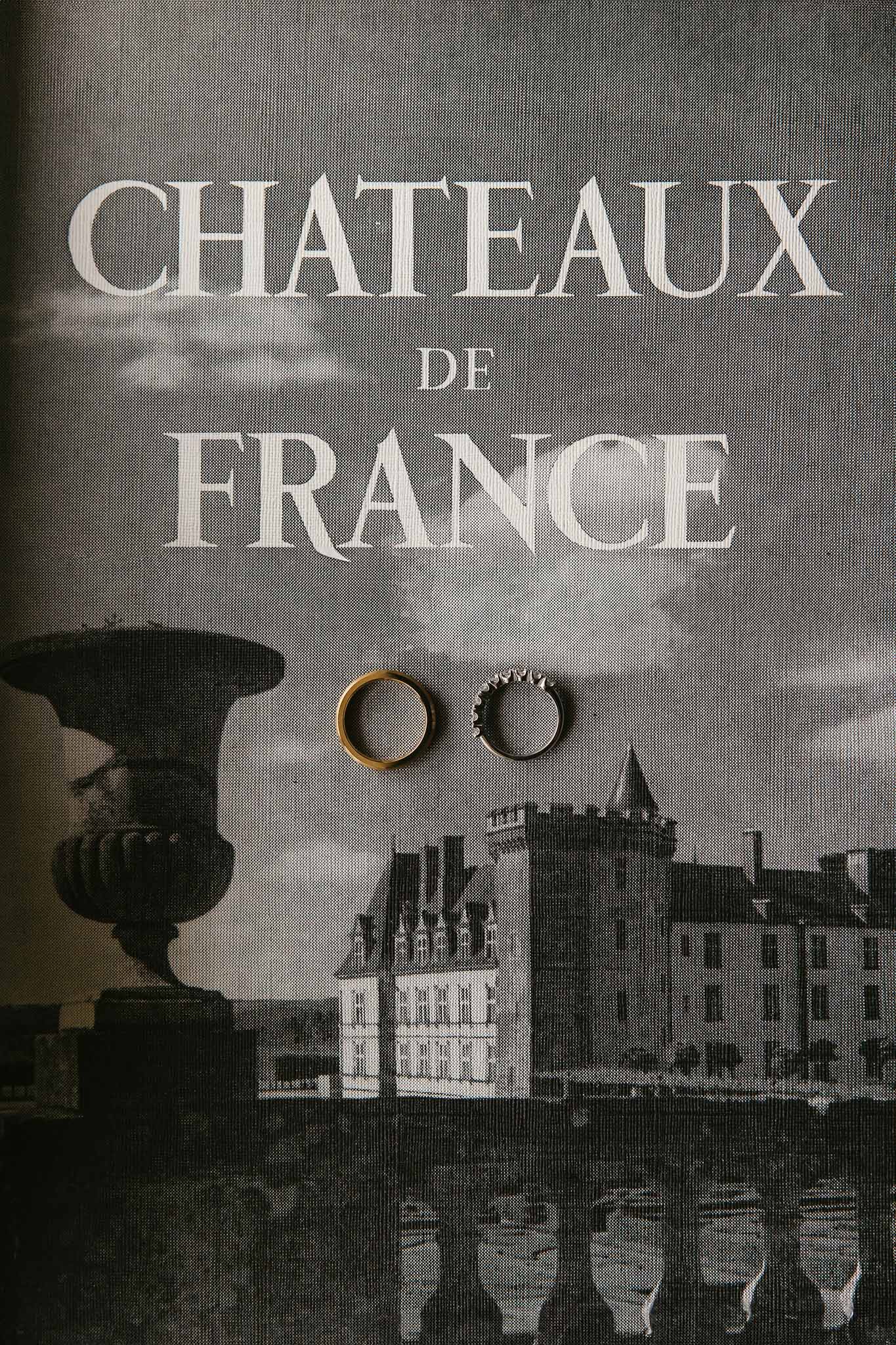Wedding rings flat lay with French chateau architectural elements and vintage typography design