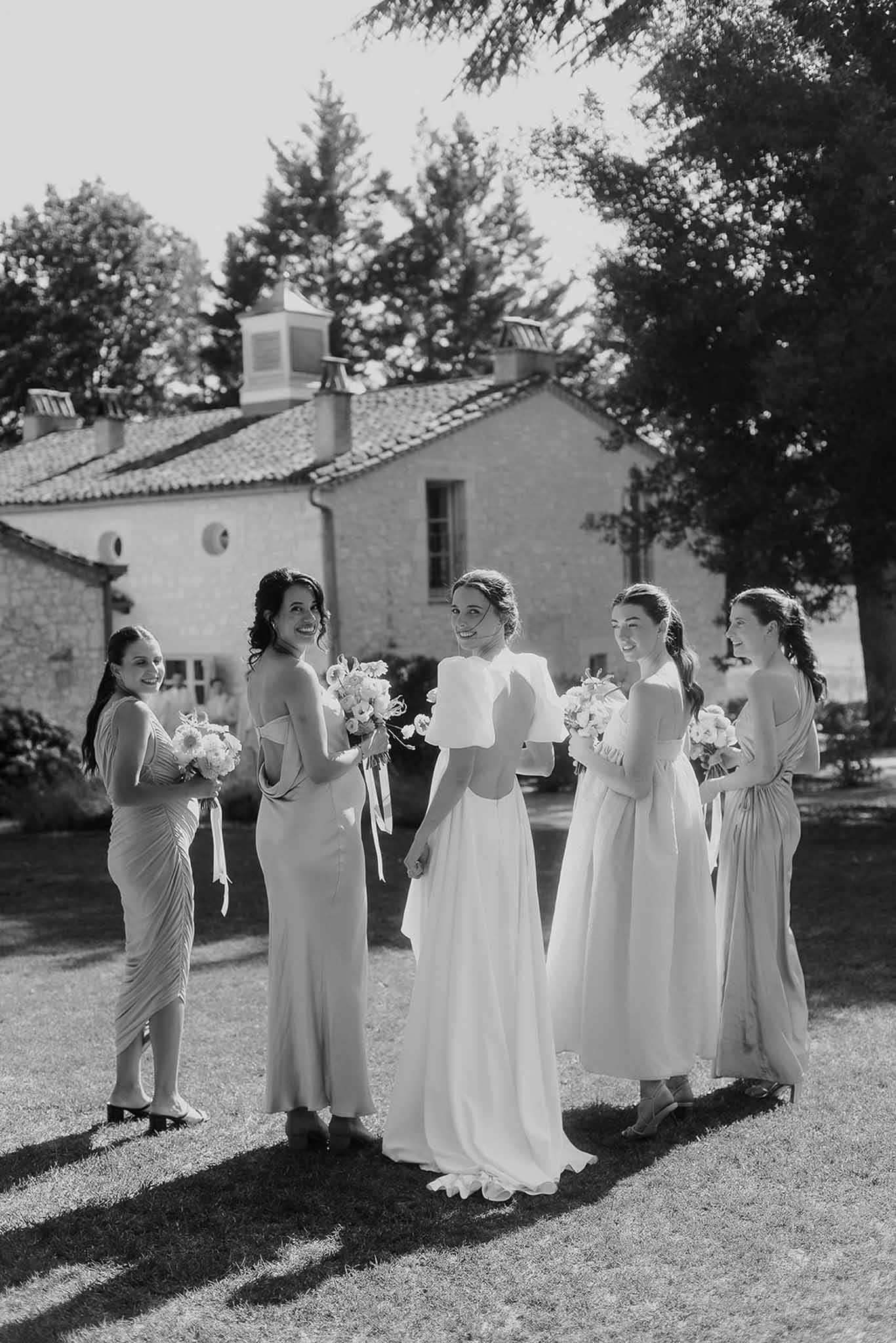 Bride and bridesmaids group portrait in Mediterranean villa courtyard