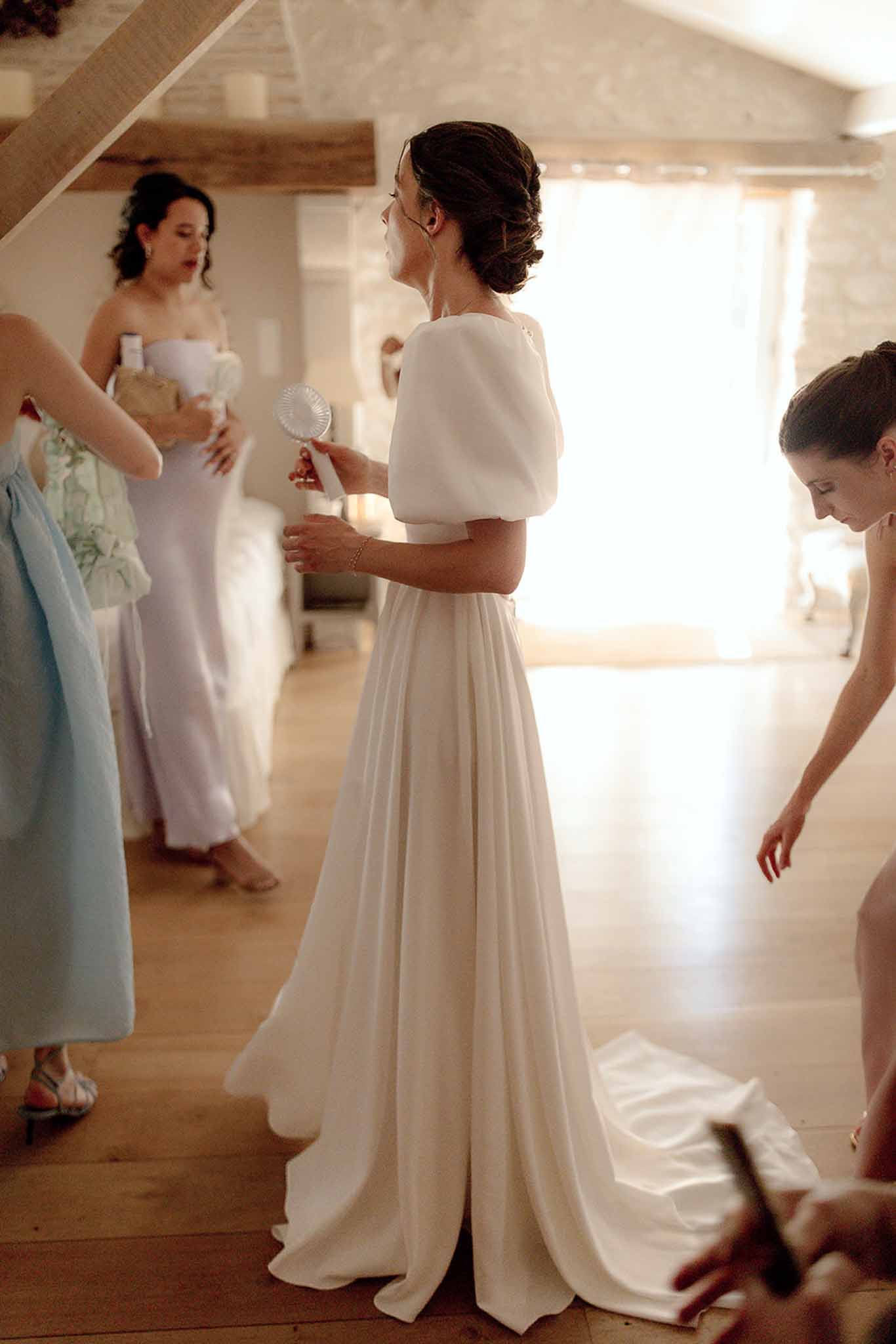 Bride getting ready with bridal party in modern indoor venue with natural light