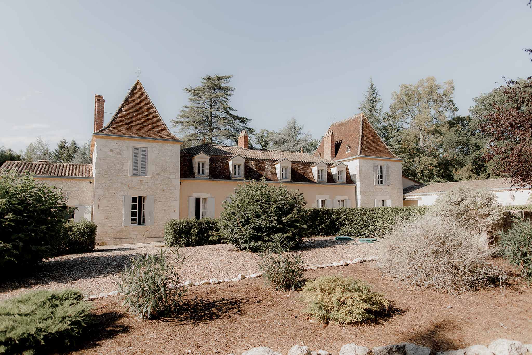 French château wedding venue exterior with stone architecture and landscaped grounds