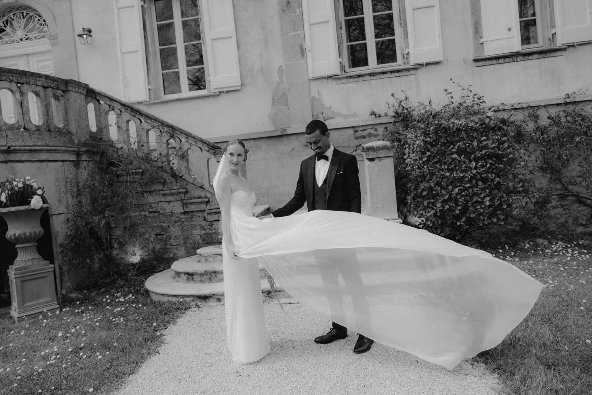 Bride and groom portrait in classical stone courtyard with European architecture