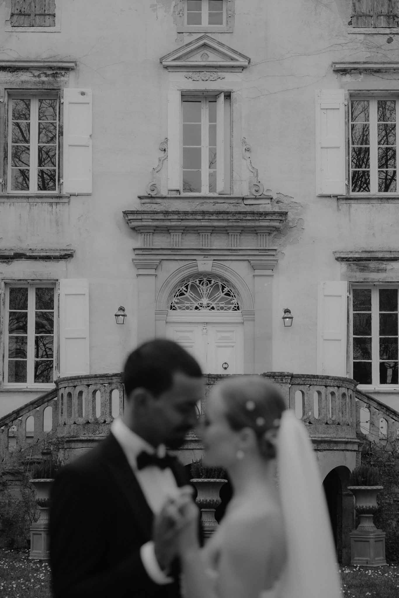 Bride and groom portrait in front of classical European building with neoclassical architecture