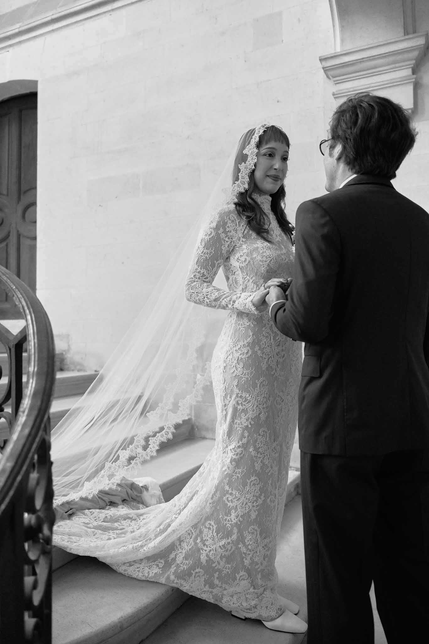 Bride and groom intimate portrait in classical indoor venue with lace wedding dress