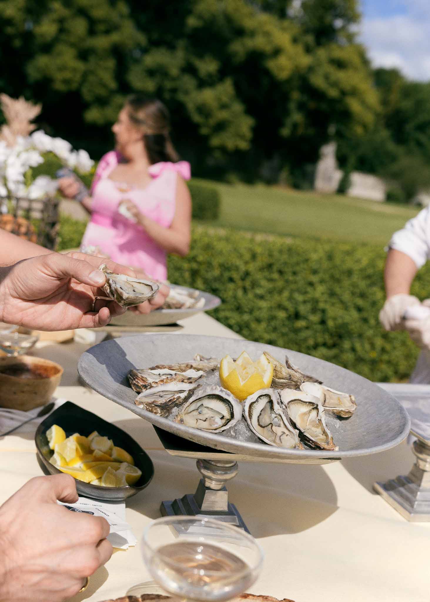 Fresh oysters served during cocktail hour at outdoor garden wedding reception