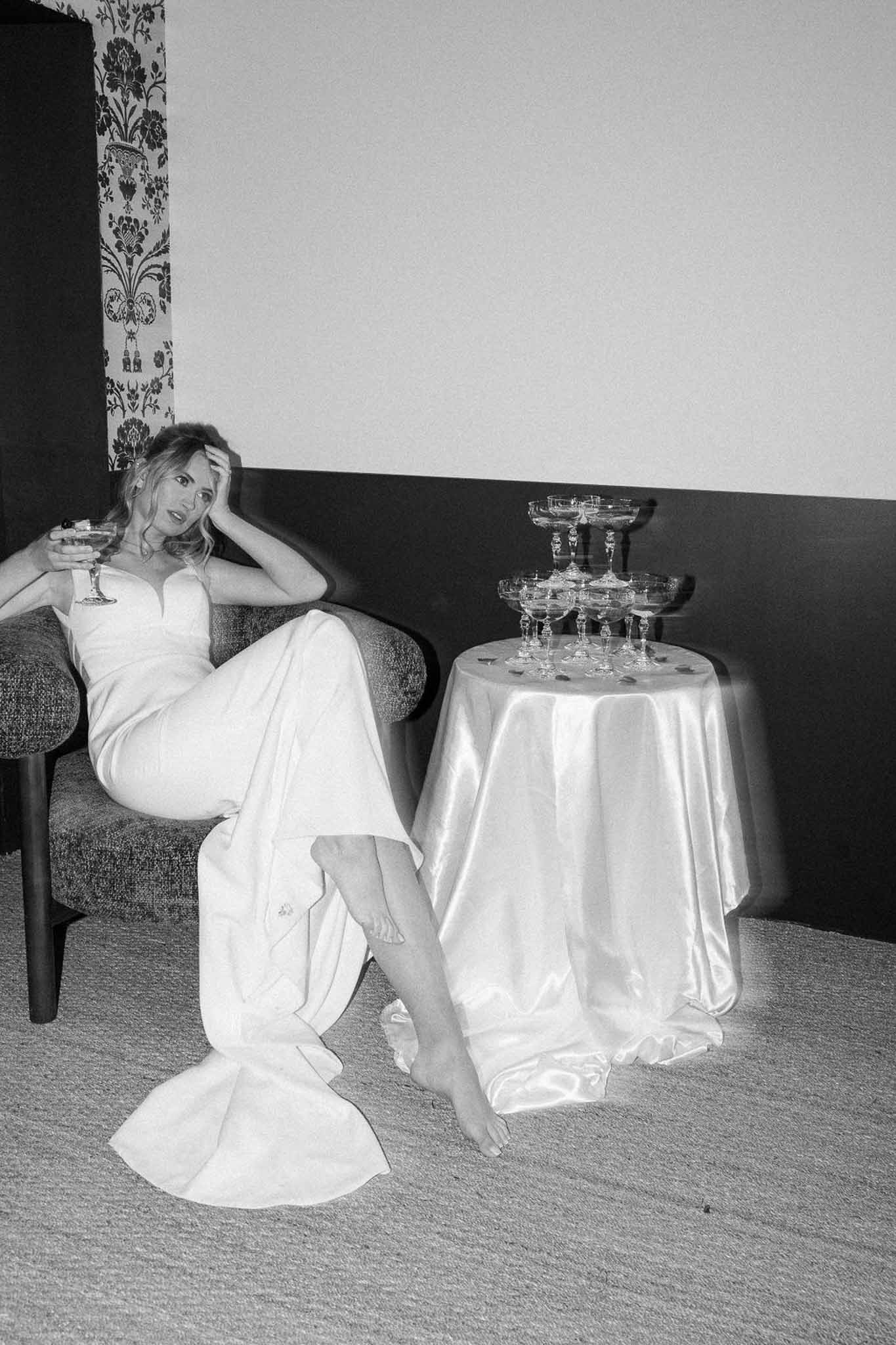 Bride portrait with champagne tower in elegant ballroom reception setting