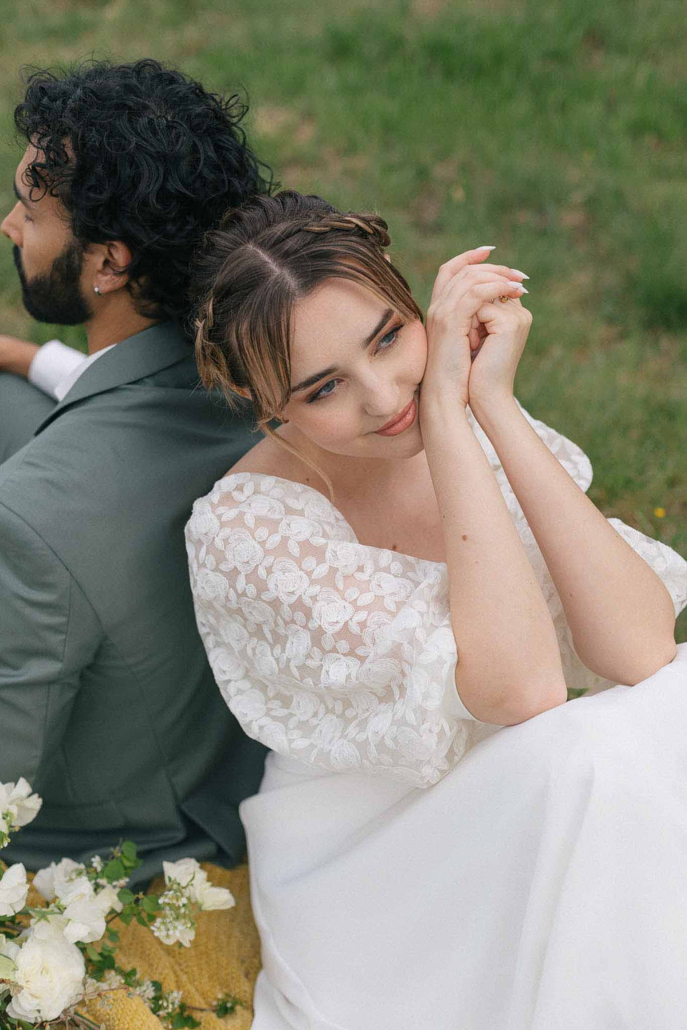 Bride and groom intimate portrait in outdoor garden setting with white rose bouquet